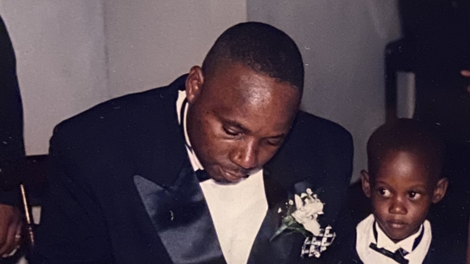 A man and a boy in wedding suits