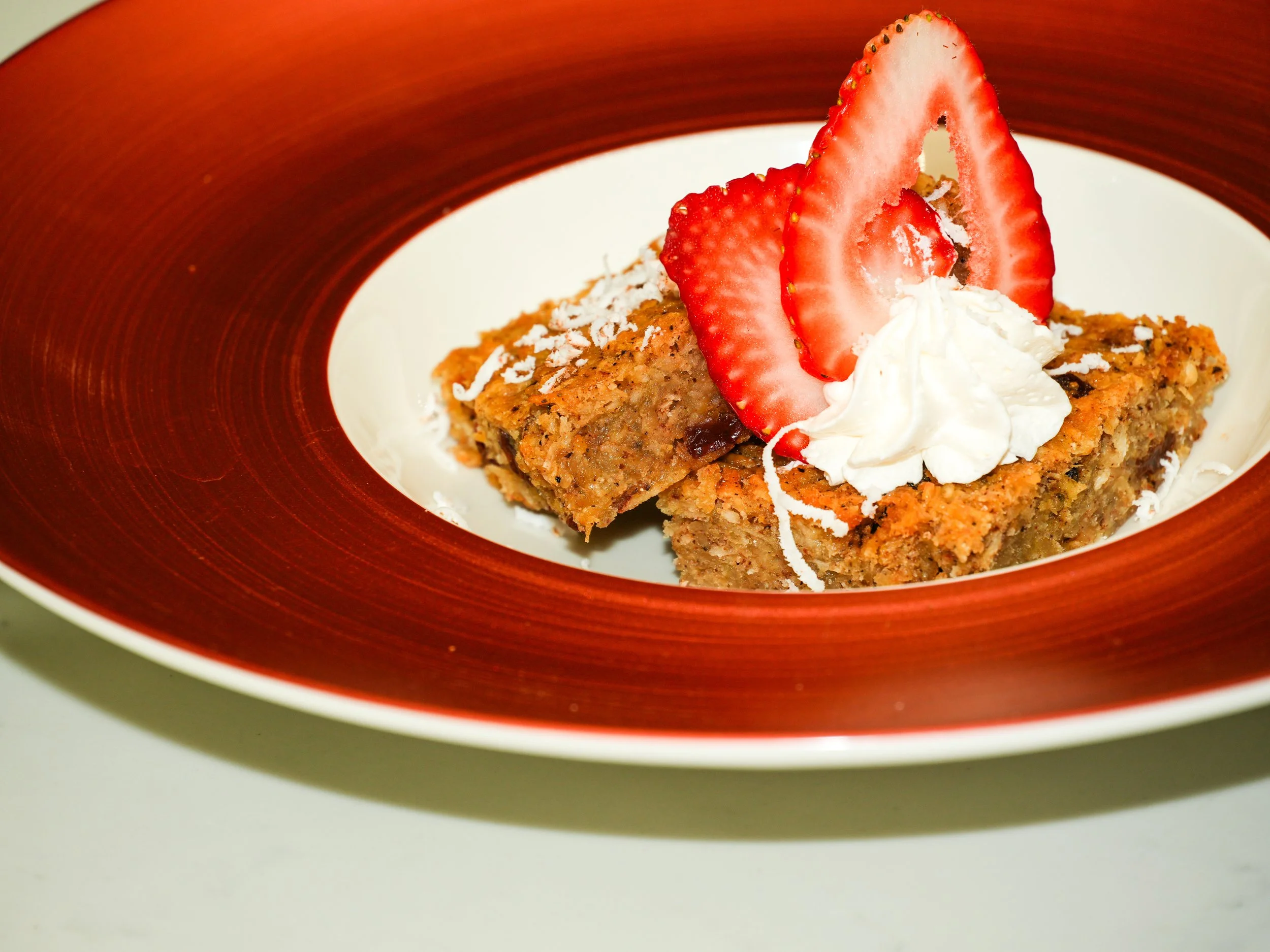 A cherished Caribbean dessert, our Caramelized Cassava Cake, traditionally known as pone, is made with freshly grated cassava, coconut, and warm spices, then slow-baked to achieve its signature rich, caramelized texture. Deeply rooted in Guyanese and