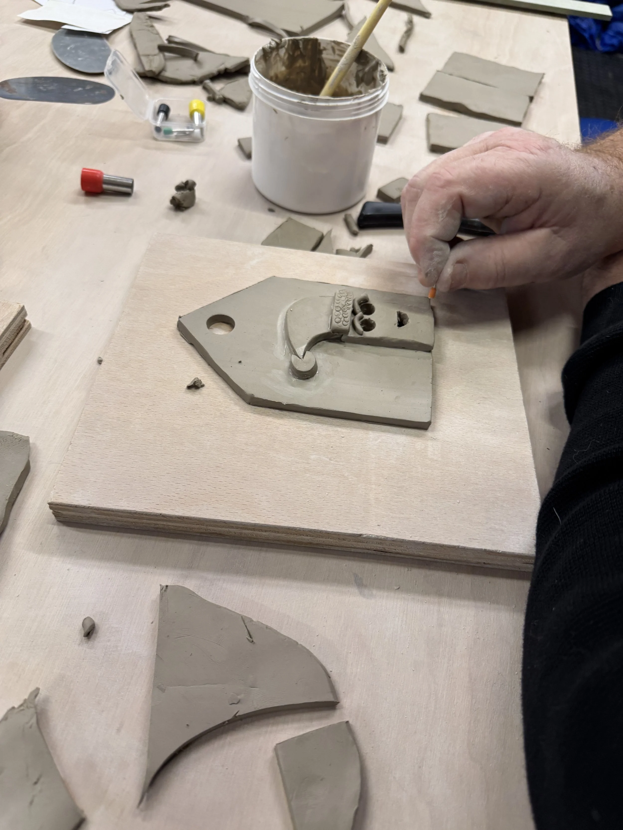 A Henfield pottery student making a Christmas Tealight House