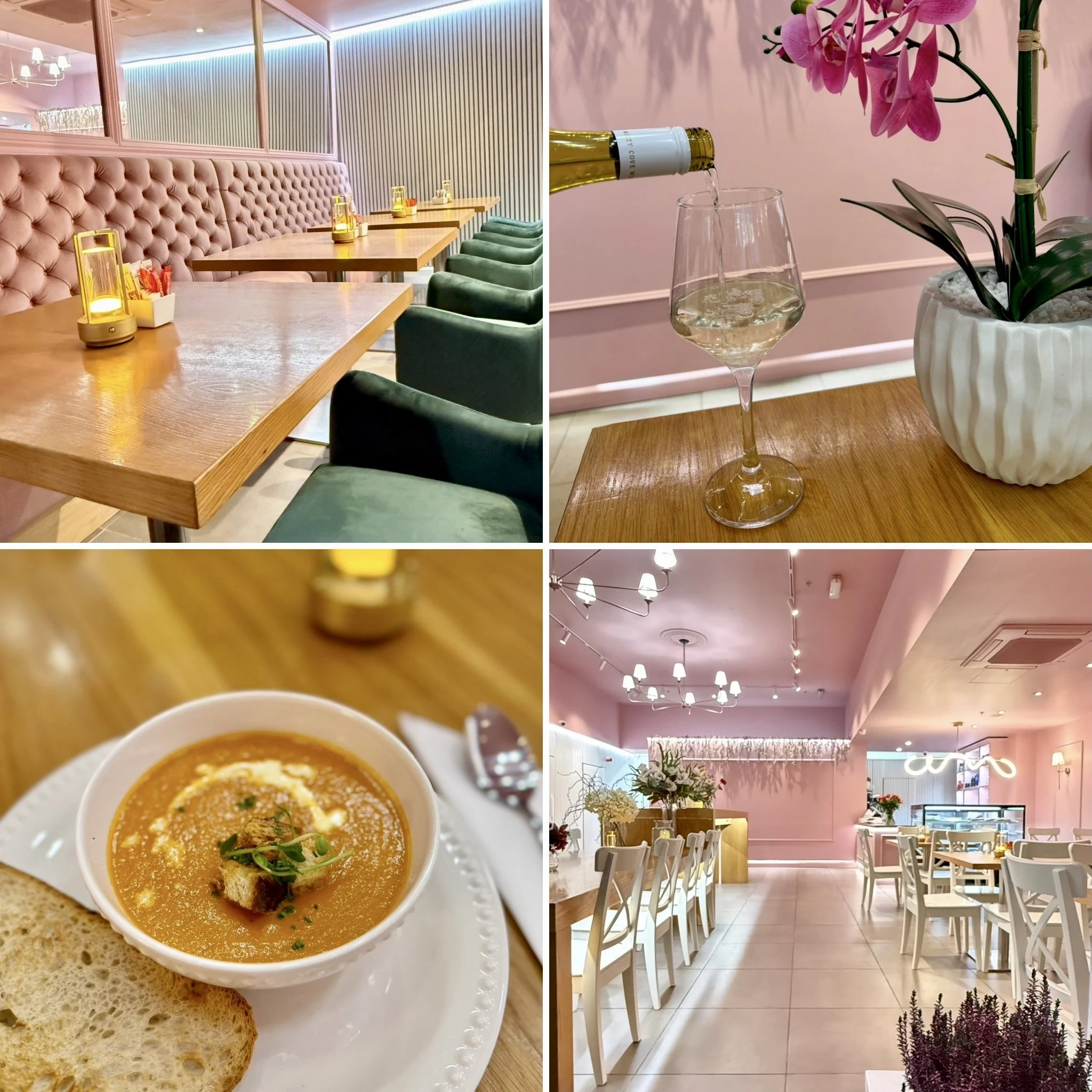 A cozy restaurant interior with pink walls, white chairs, and wooden tables decorated with small lanterns. The ceiling has multiple chandeliers and ceiling fans.