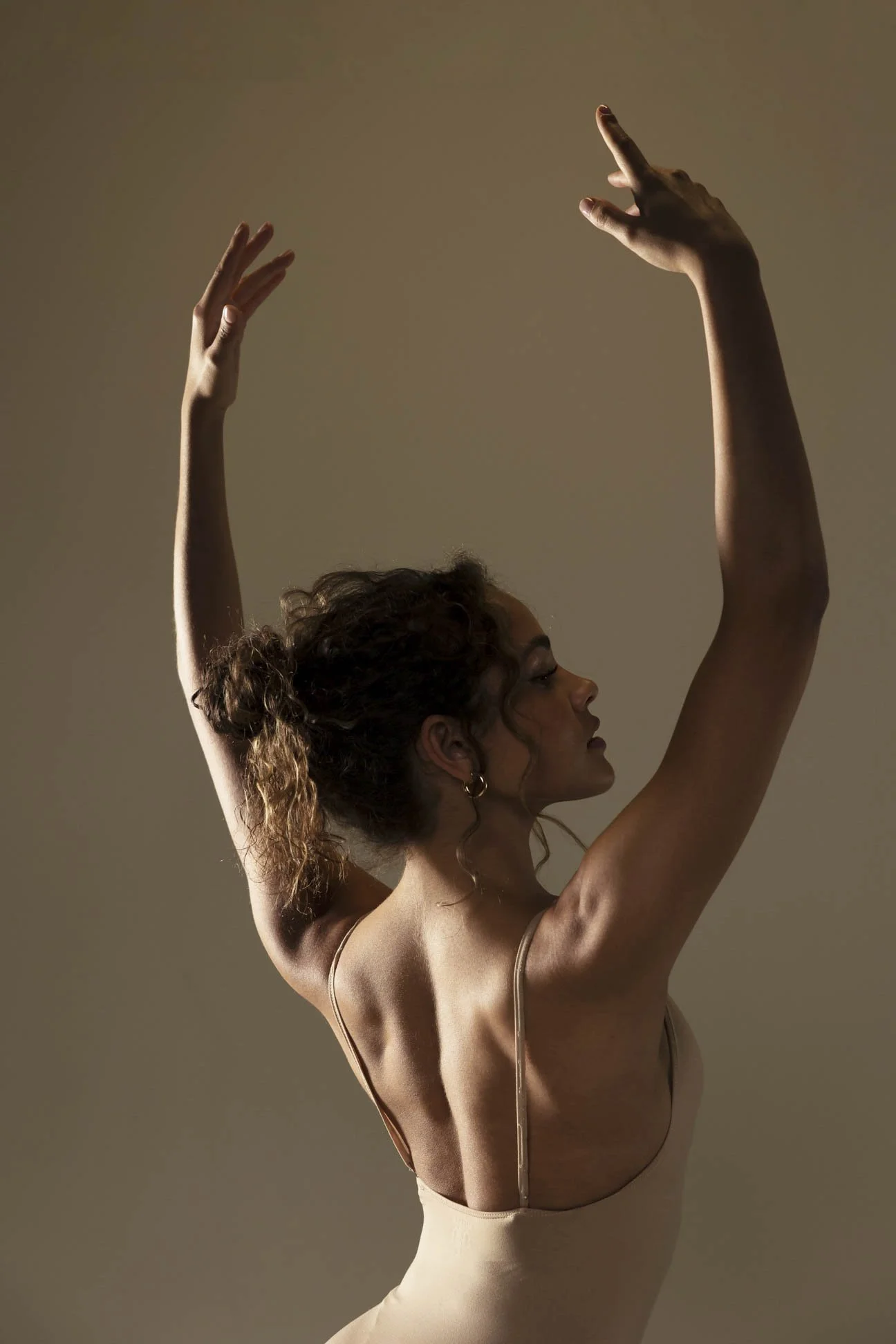 Dance image showcasing the back muscles of a dancer