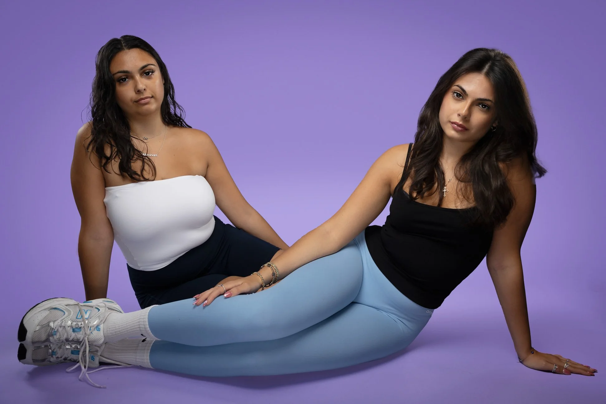 Active ware photo where models are wearing Define leggings and TNA tank top from Aritsia with purple background