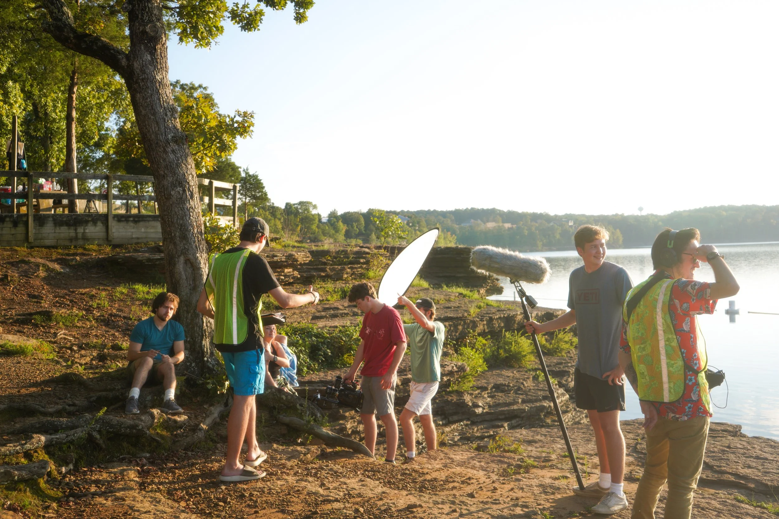 A behind-the-scenes image from the movie "Sonder" by Aidan Kolokithas featuring himself and his crew in the middle of shooting a cliff scene during sunset.