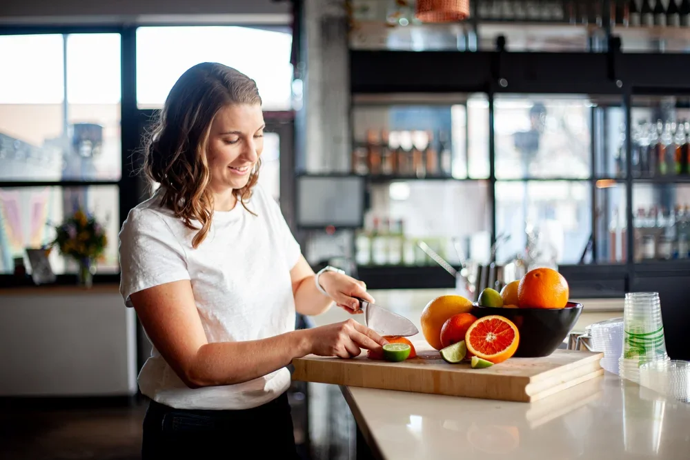 Preparing fresh citrus in the kitchen — nourishing fertility nutrition