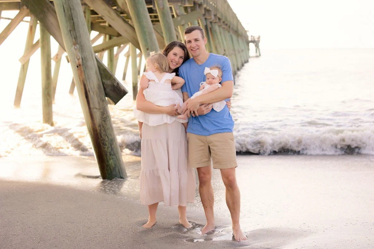 Family of four at the beach at sunset — growing a family after fertility struggles