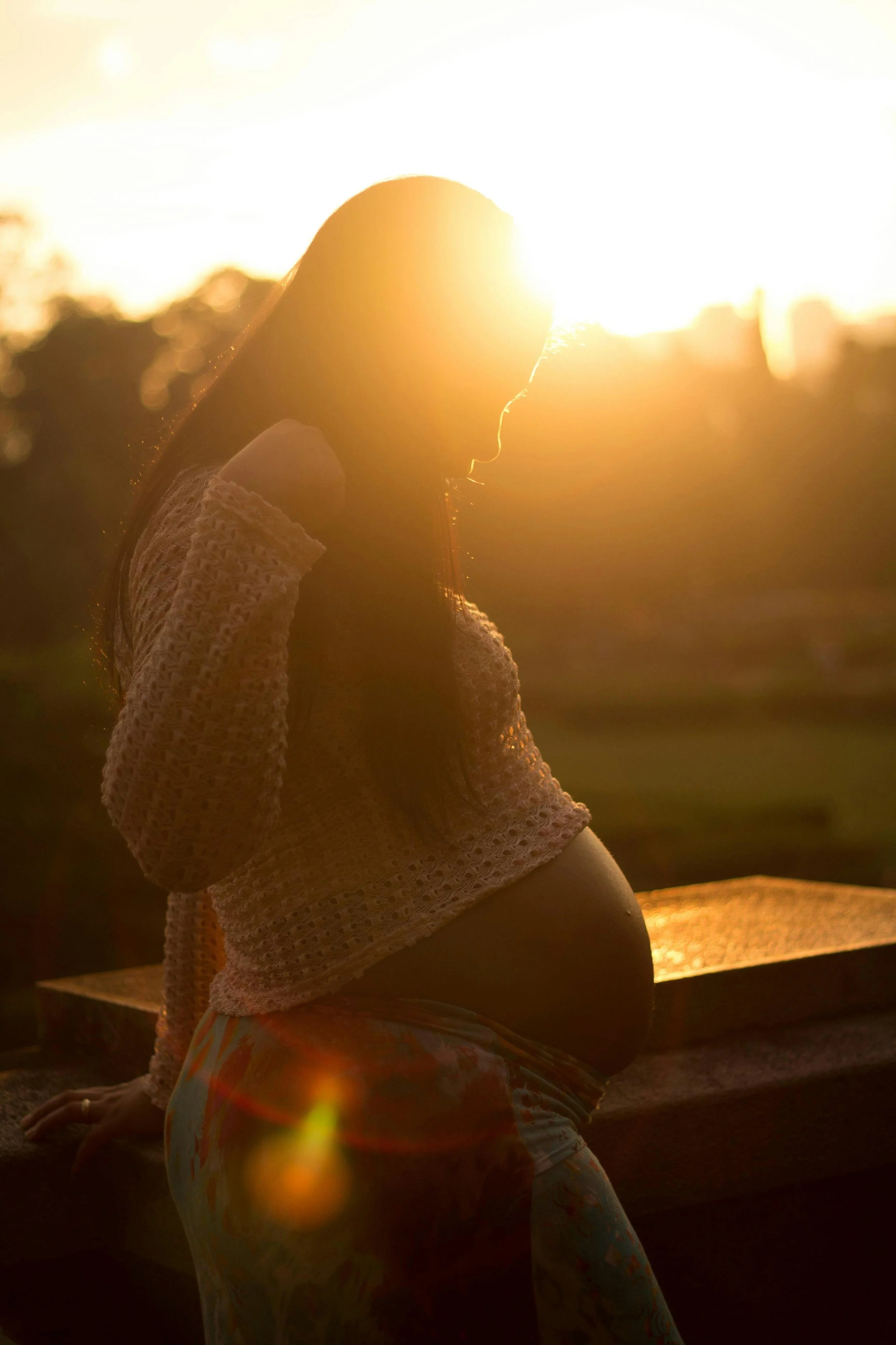 Woman reflecting at sunset — emotional support through the fertility journey