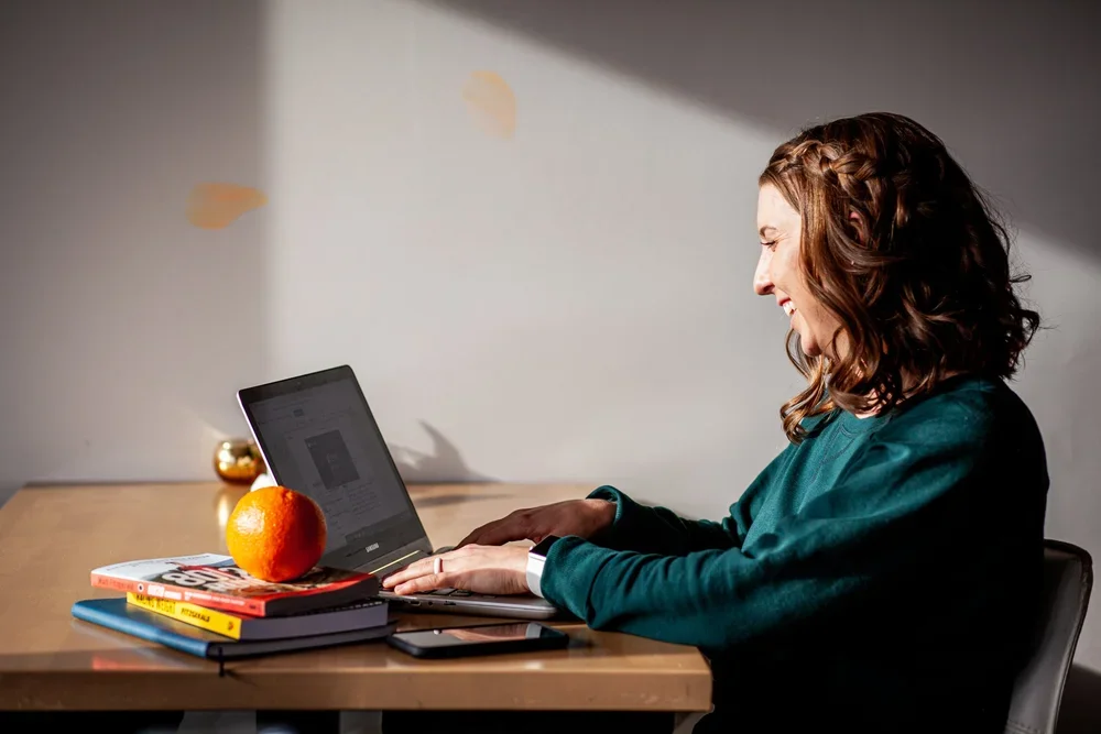 Fertility nutritionist offering virtual coaching at her laptop