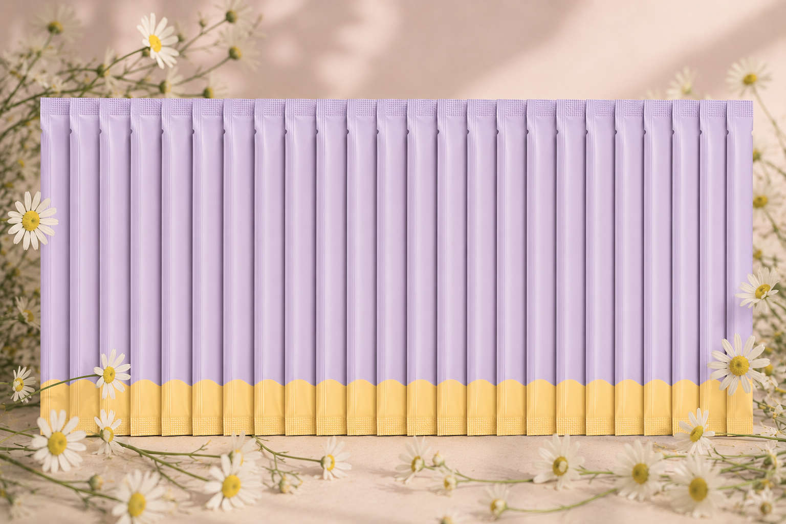 A row of purple and yellow packaged snacks arranged vertically on a surface, surrounded by white daisies with yellow centers and small green stems.