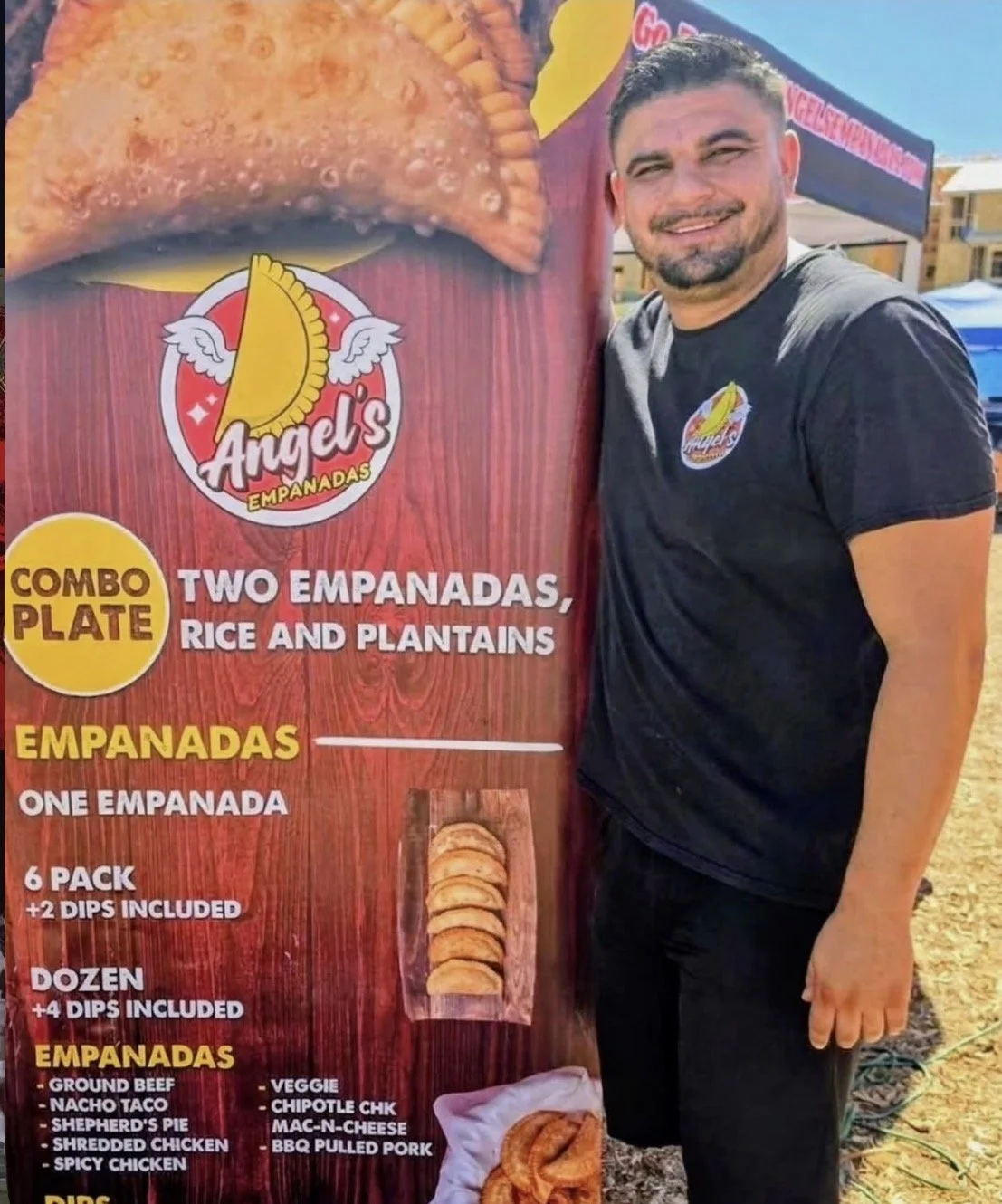 Angel’s Empanadas market booth with branded menu banner
