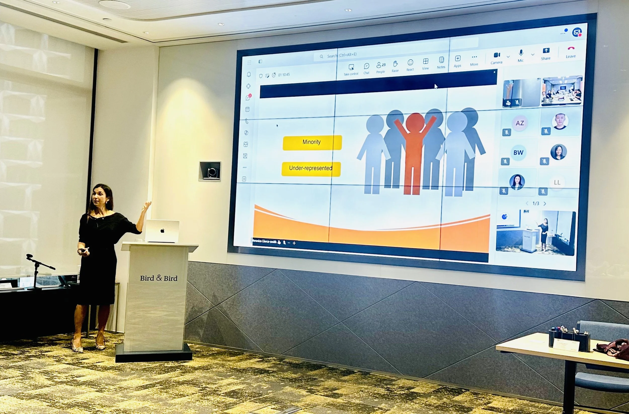 Woman pointing at a screen in a public workshop
