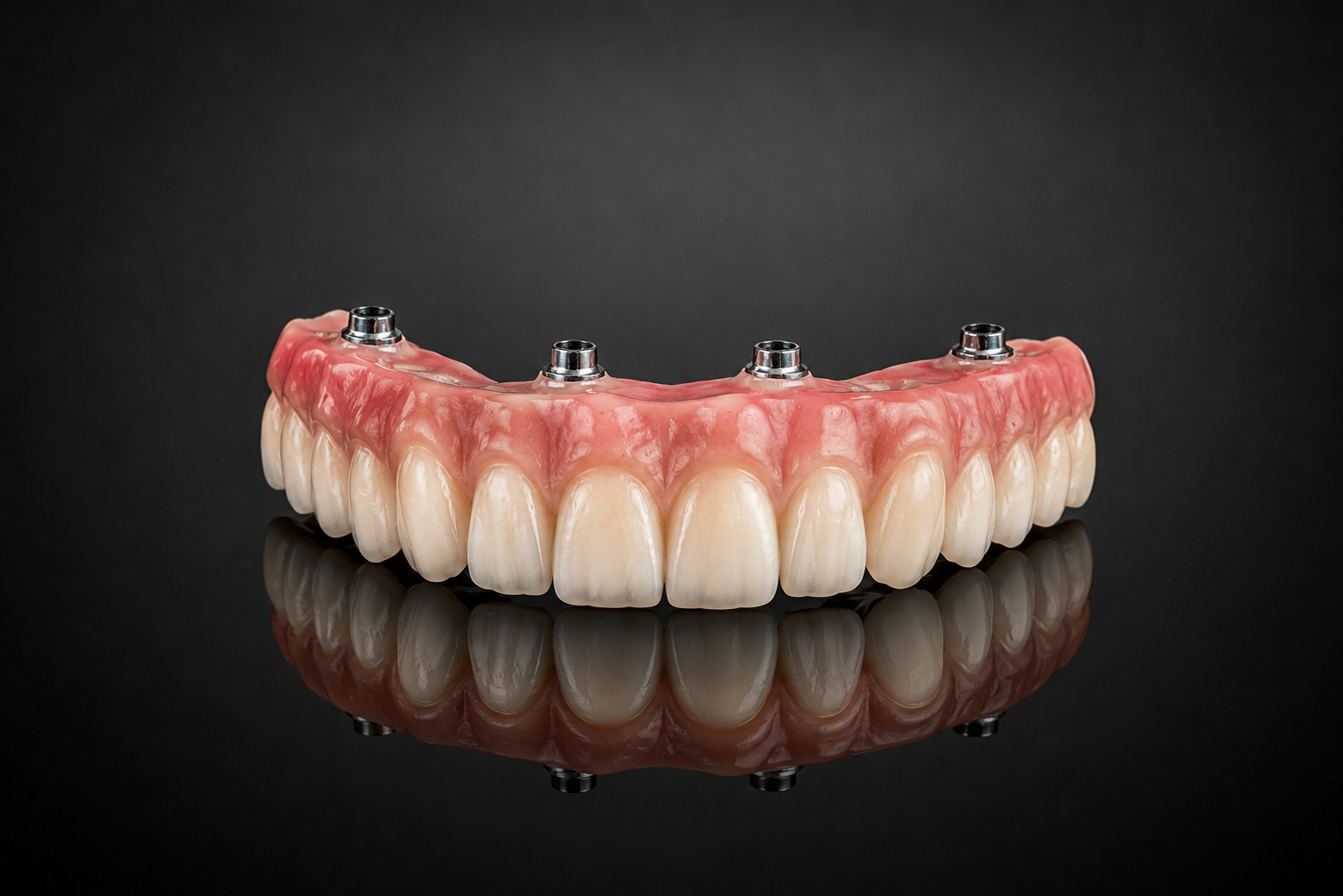 A set of dental implant dentures on a black reflective surface with a dark background.
