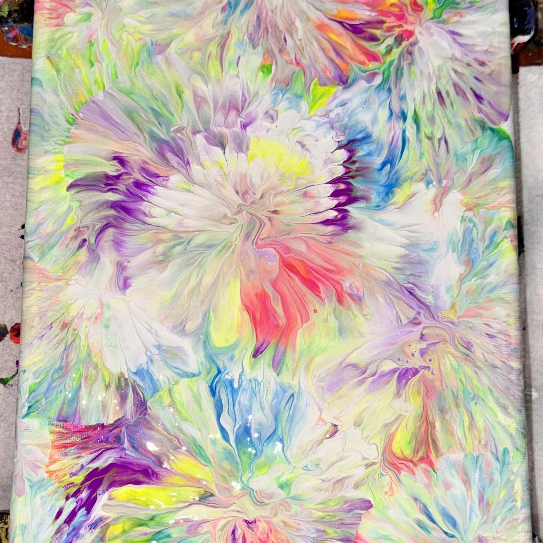 Abstract colorful painting with swirling pastel colors including purple, pink, yellow, green, blue, and white.