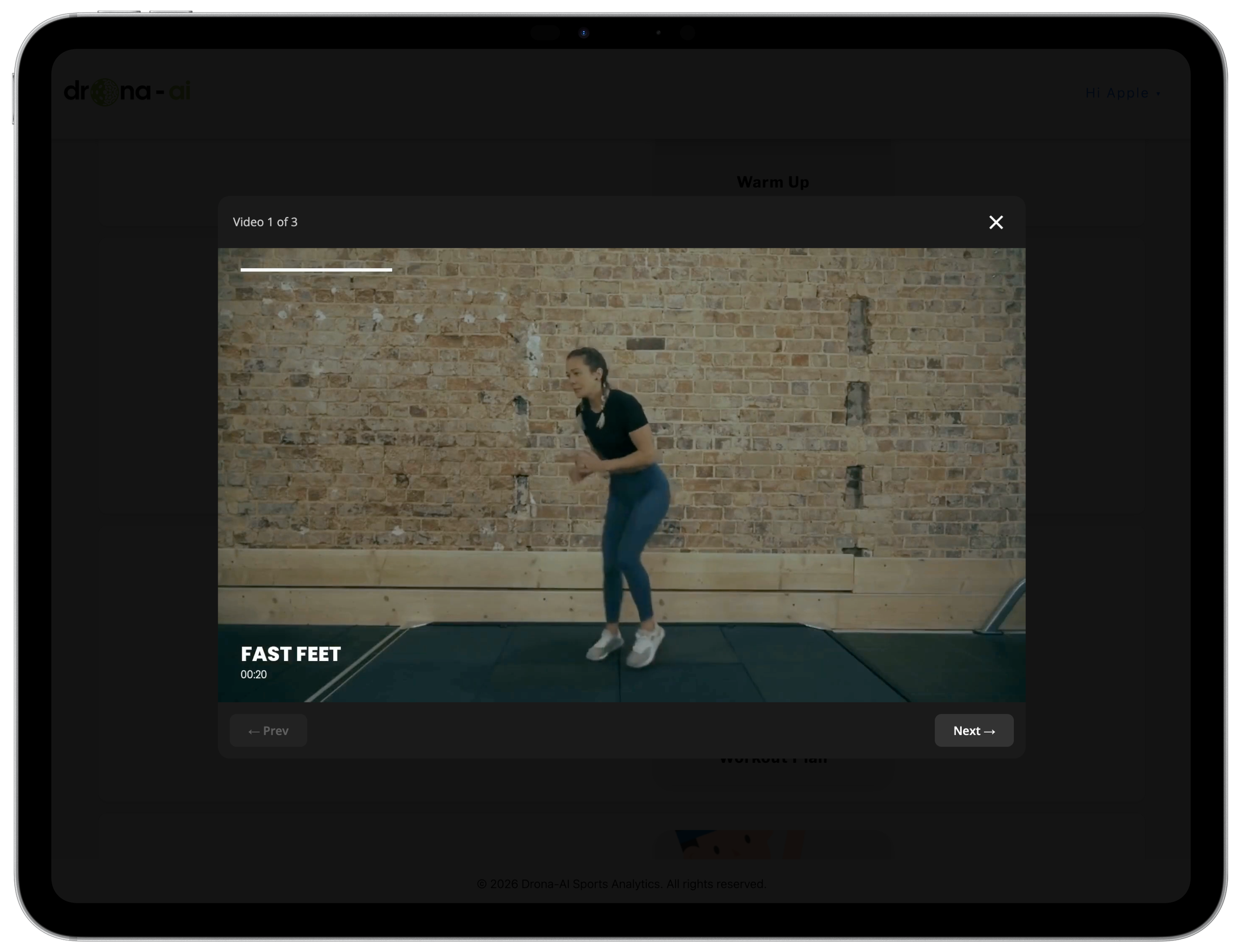 A woman in athletic clothing performing a jump in a gym with a brick wall background. The video is titled "FAST FEET" and has a duration of 20 seconds.