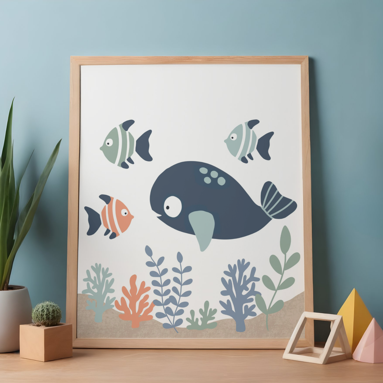 Decorative framed print of colorful underwater fish and coral scene, on a blue wall with a plant and small decor items nearby.
