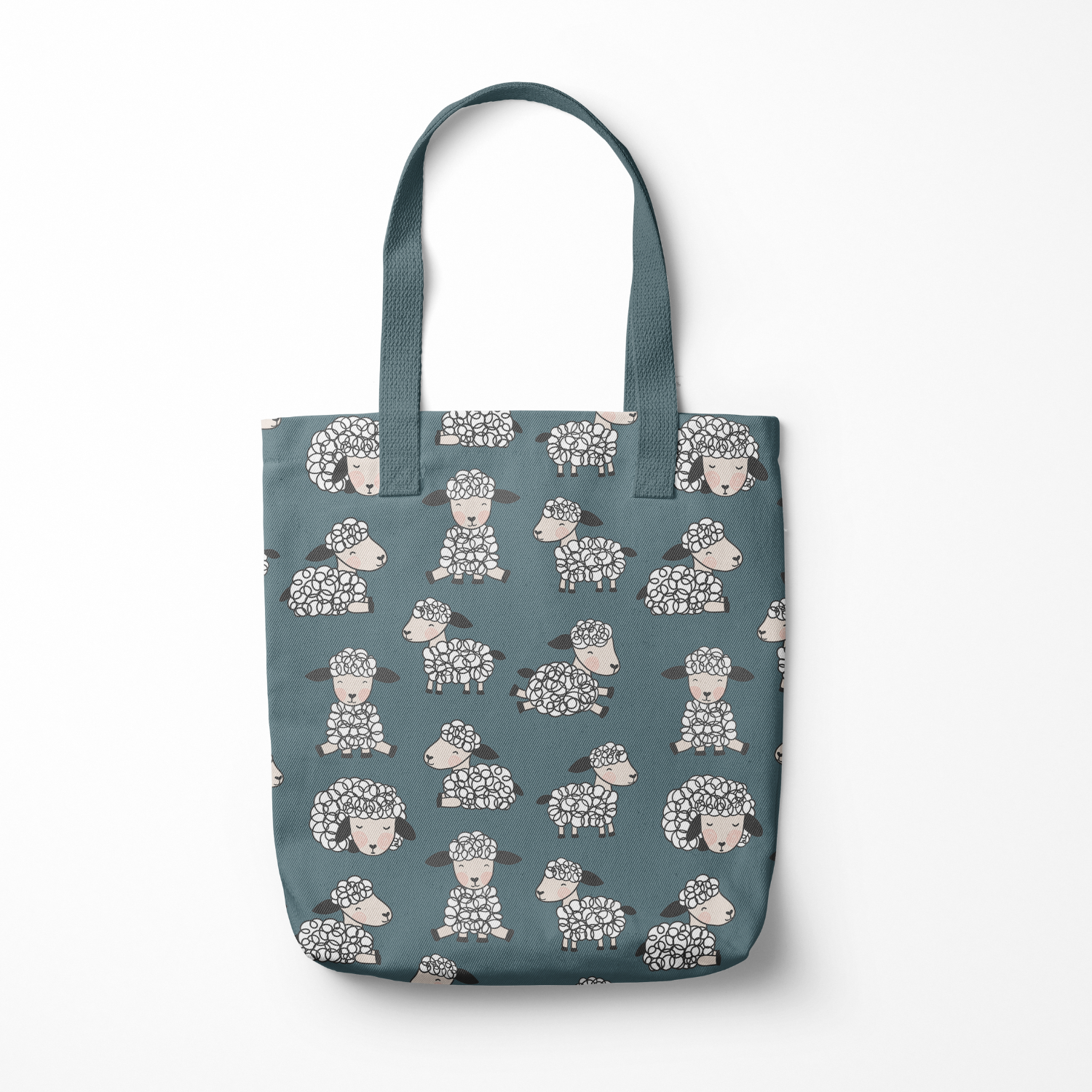 Blue tote bag with a pattern of illustrated sheep with curly wool and smiling faces, on a white background.