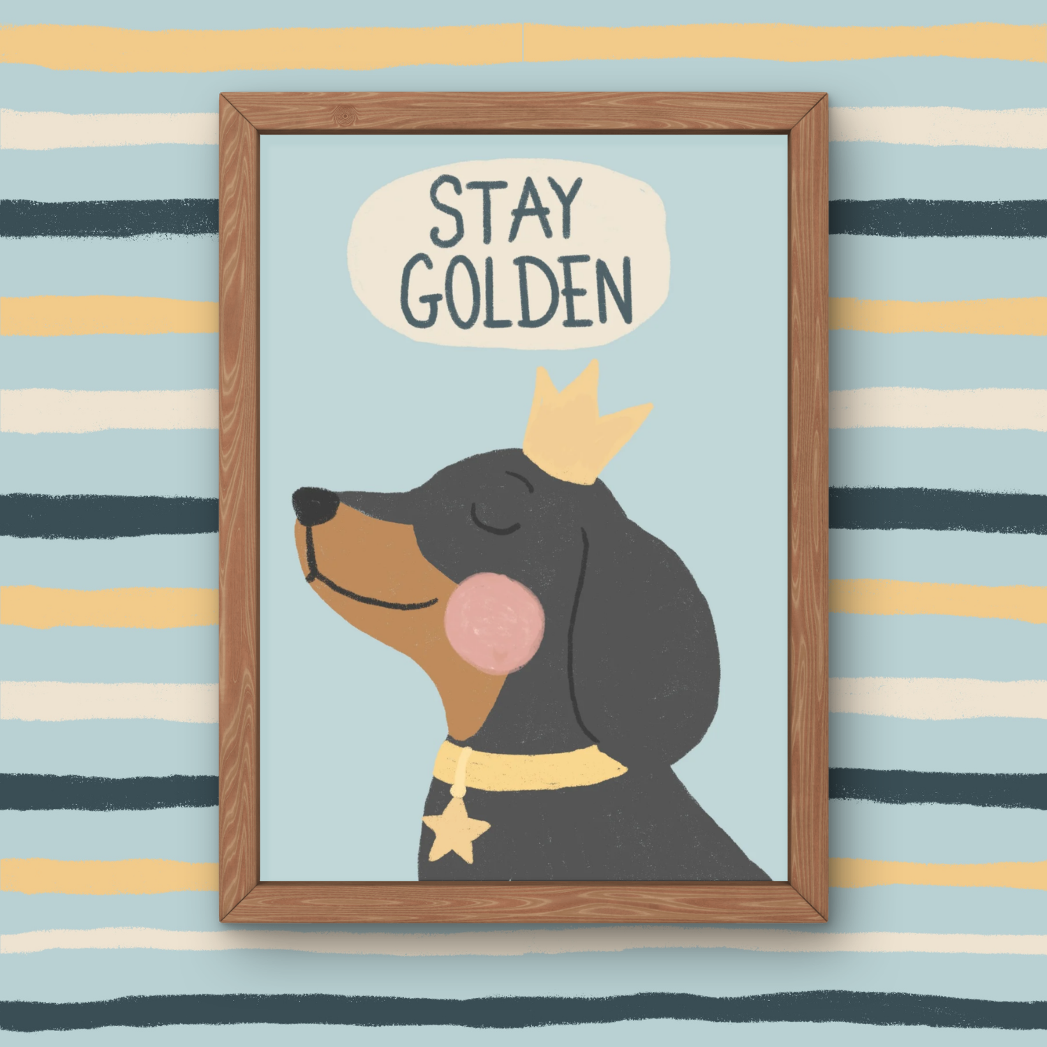 A framed illustration of a smiling dog with a crown and a star-shaped necklace, with the words "STAY GOLDEN" in a speech bubble above its head, set against a striped background.