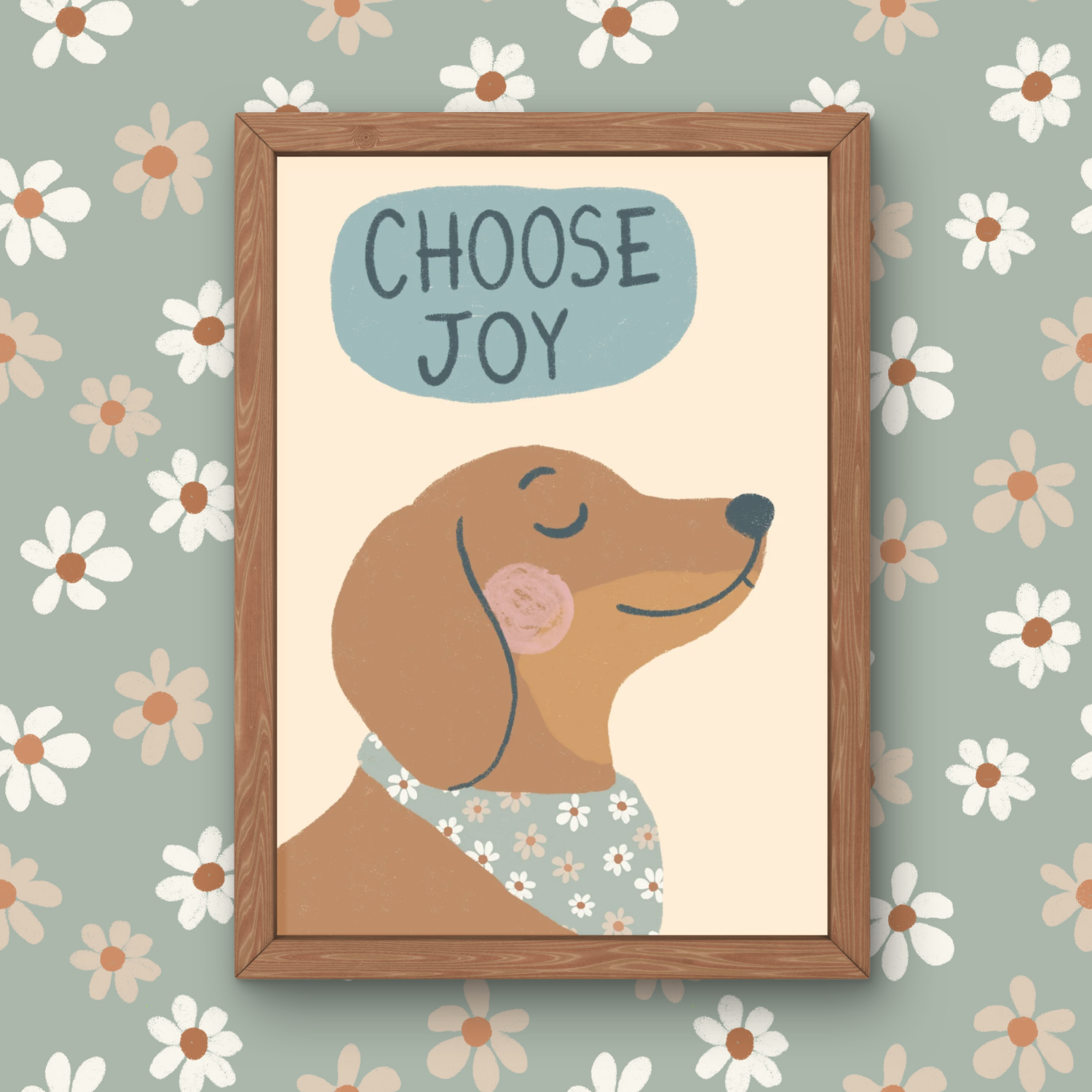 A framed illustration of a smiling dog with closed eyes, pink cheeks, and a floral bandana, with the phrase 'Choose Joy' written above in a blue oval, on a background of white daisies with brown centers on a greenish wall.
