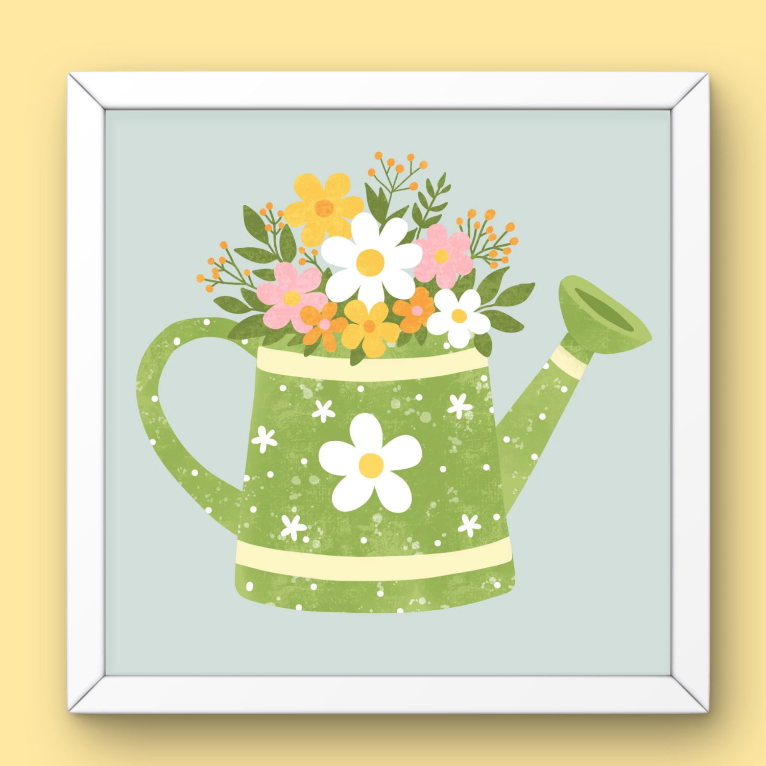 A framed illustration of a green watering can with white flowers and pink, yellow, and orange flowers overflowing from the top.