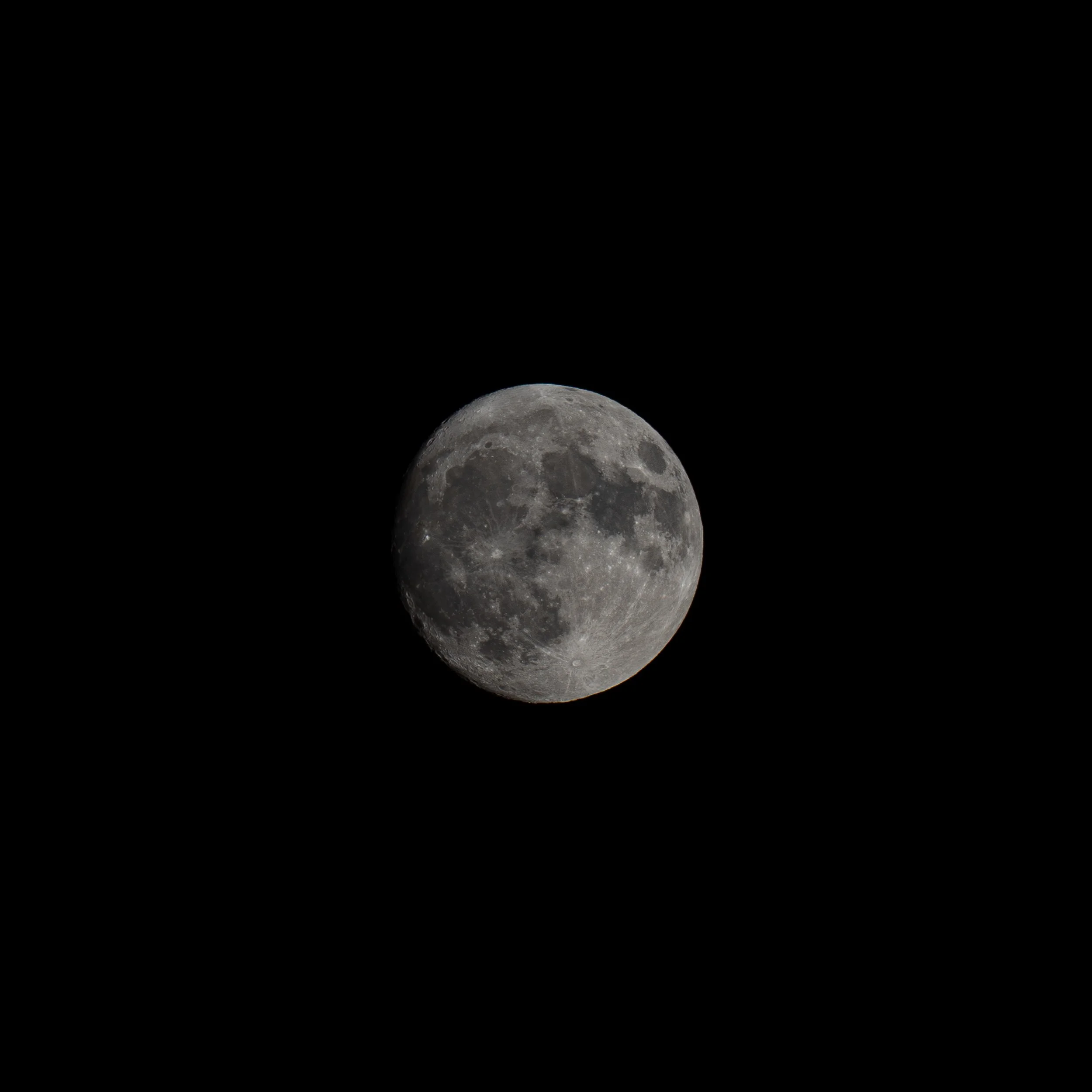 The moon's surface visible in the lower part of the dark sky.