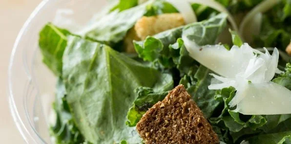 Fresh Caesar salad with croutons and parmesan cheese from a healthy restaurant in Charleston SC