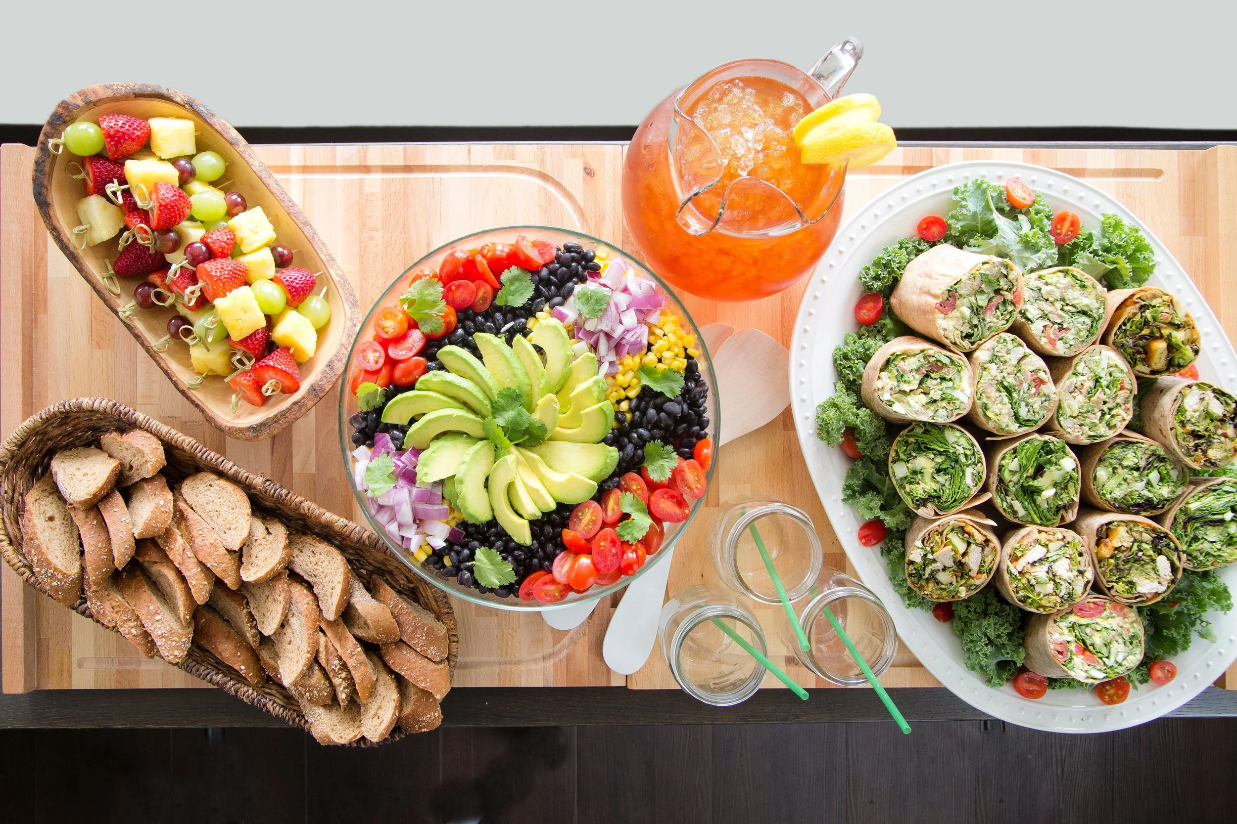 A beautifully arranged table featuring a variety of healthy foods and drinks, showcasing Verde's catering offerings in Charleston, SC.