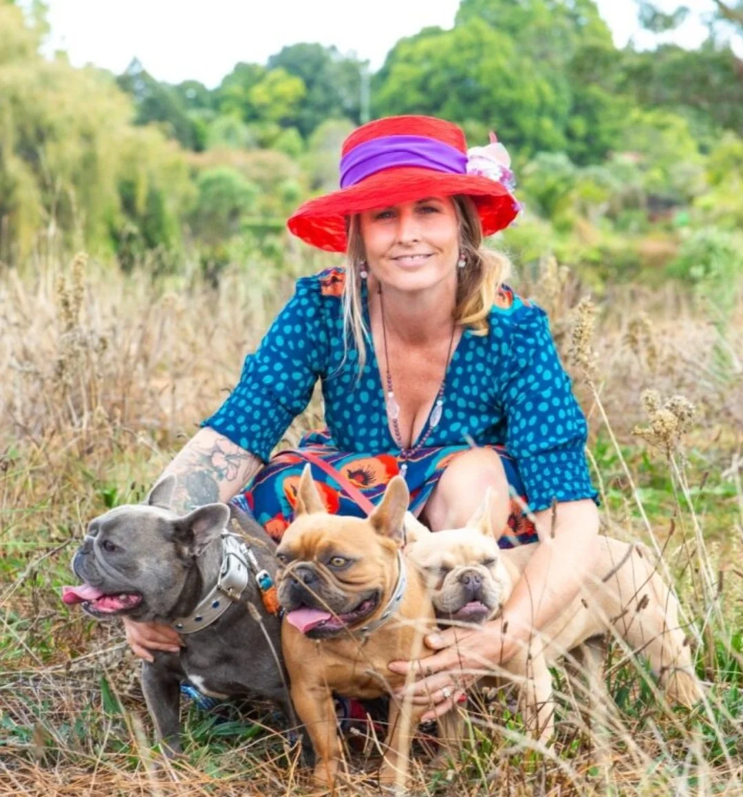 Olivia Potter of Le Epitome Kennels in Waikato, New Zealand, pictured outdoors with three coloured French Bulldogs, including blue brindle, fawn, and cream colour lines from the Le Epitome Kennels breeding programme.
