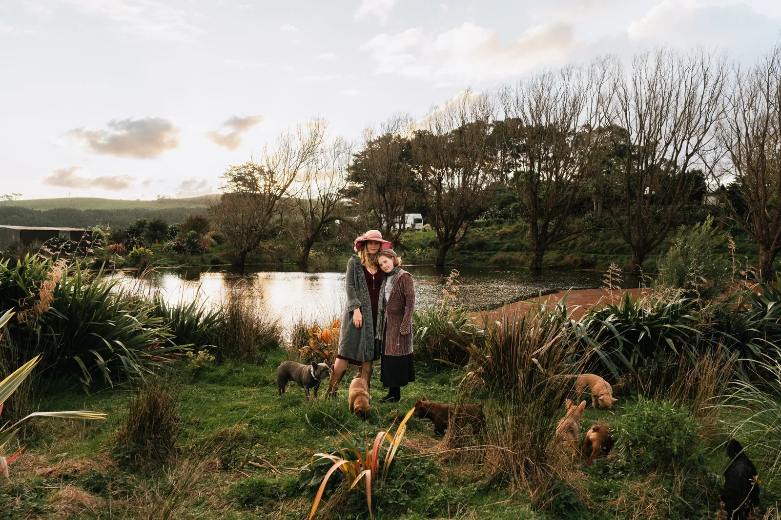Mother and Daughter with French Bulldogs beside the pond at the rural Waikato Le Epitome Kennels.