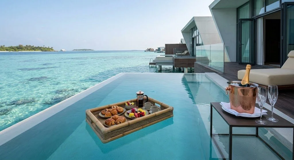 The Azure Sanctuary:
A morning suspended between sky and sea. Enjoy a gourmet breakfast floating in your private infinity pool over an untouched turquoise lagoon. Sleek, modern architecture fades away, leaving absolute seclusion.
