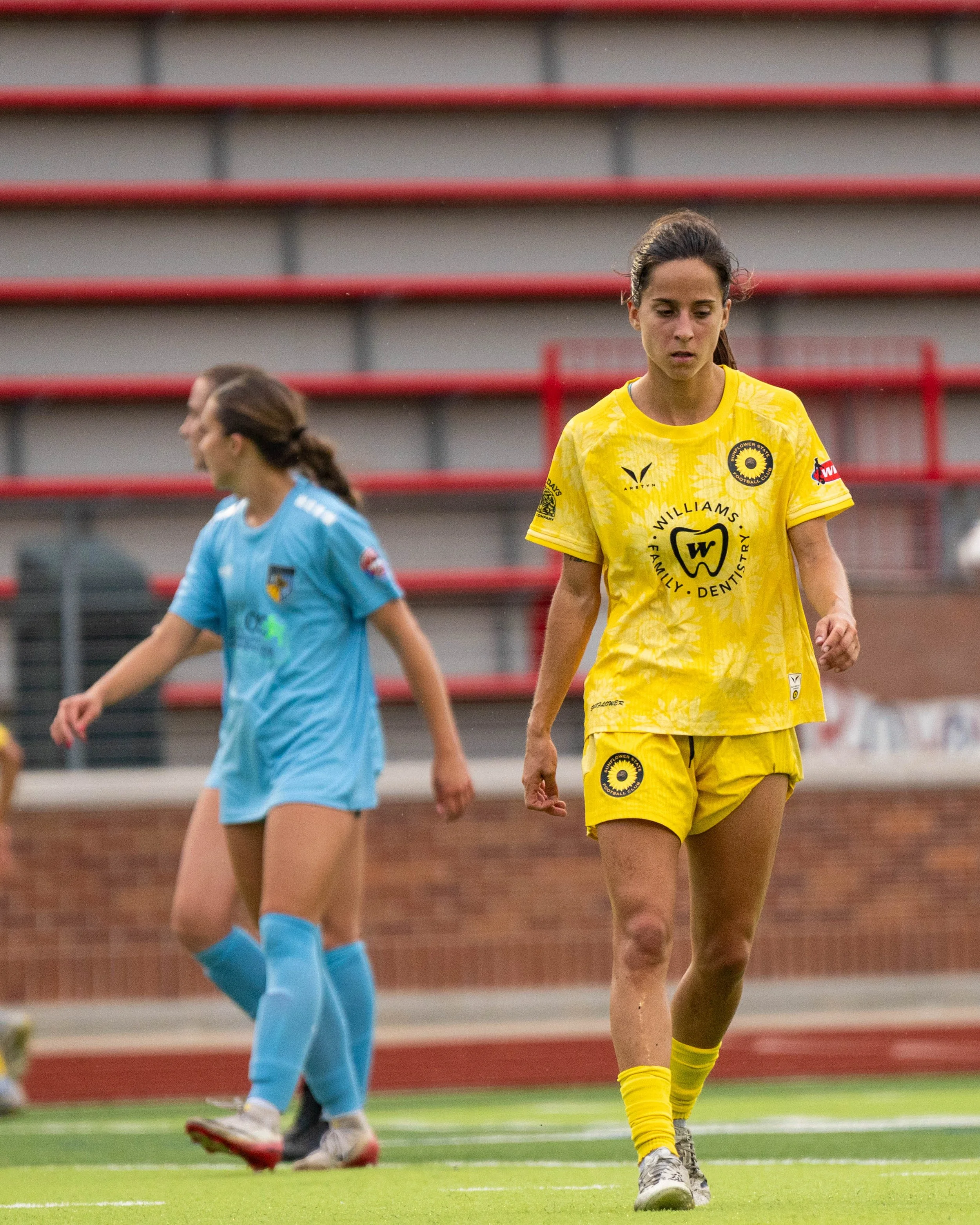 Sunflower State FC player walking with opponents in the background at home against Oklahoma City FC on June 6th, 2026 - Photo by: Austin Farrow