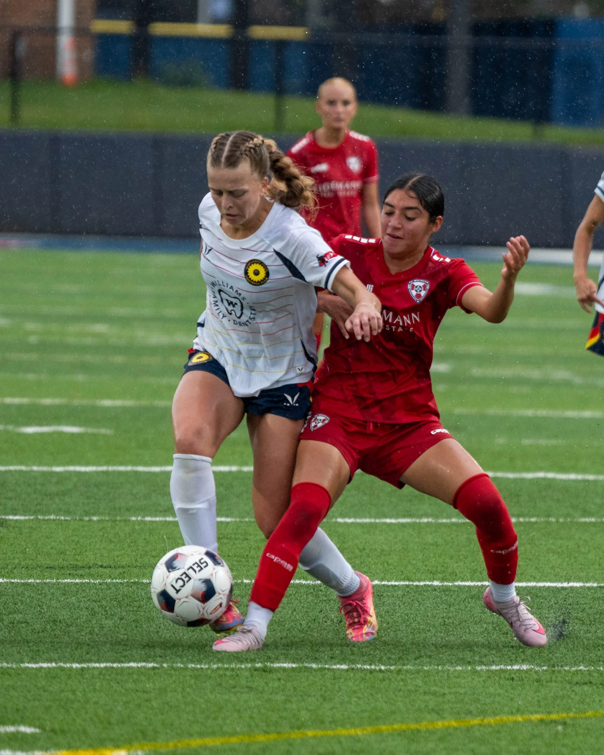 Sunflower State FC's Juliana Wardlaw (#8) dribbles past an opponent while it is pouring rain vs Wichita FC on June 7th, 2026 - Photo by Austin Farrow