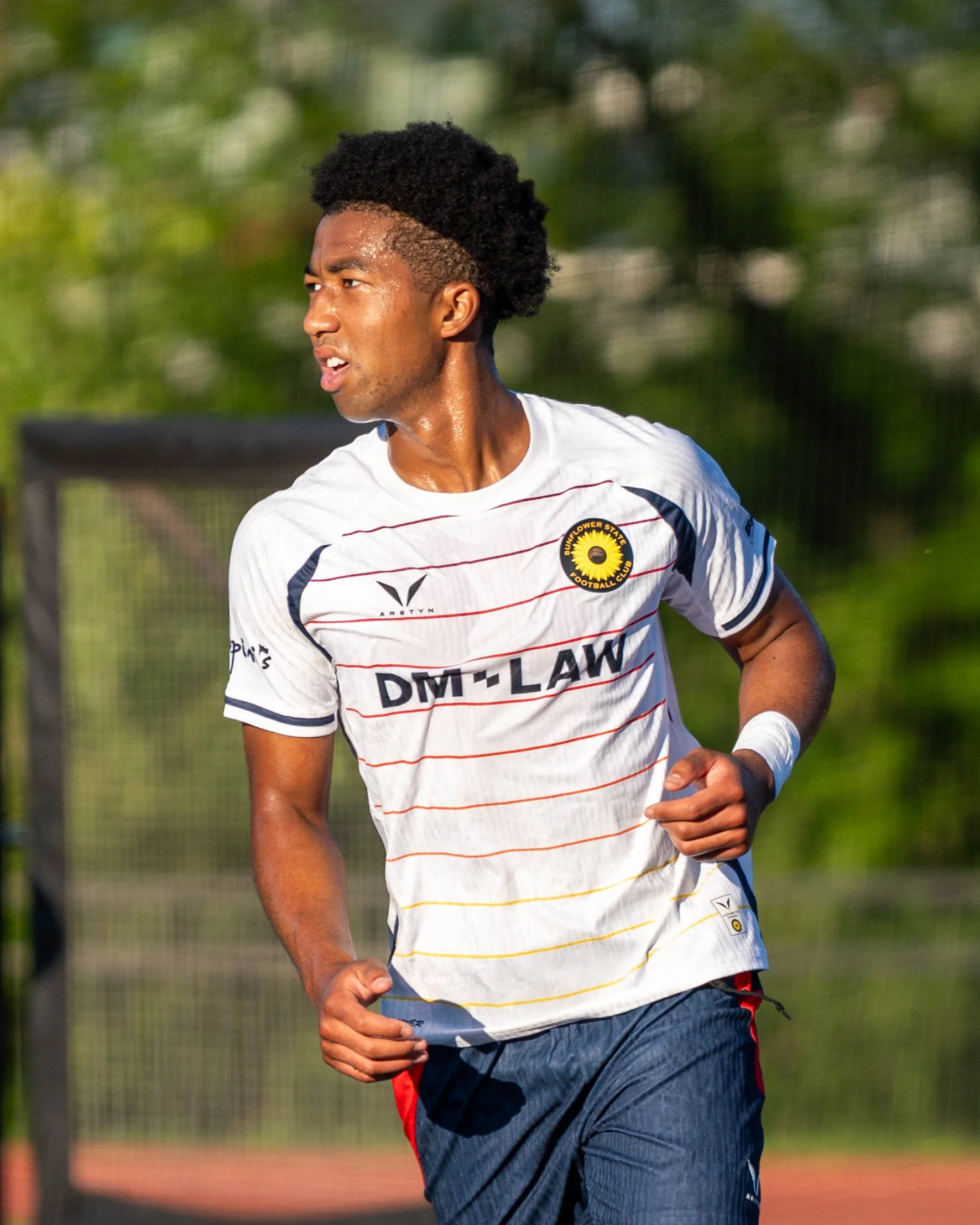Closeup shot of Sunflower State FC's Immanuel Wayoro (#7) after scoring a goal and rushing back to restart play on the road against FC Ambush on June 13th, 2026 - Photo by: Austin Farrow
