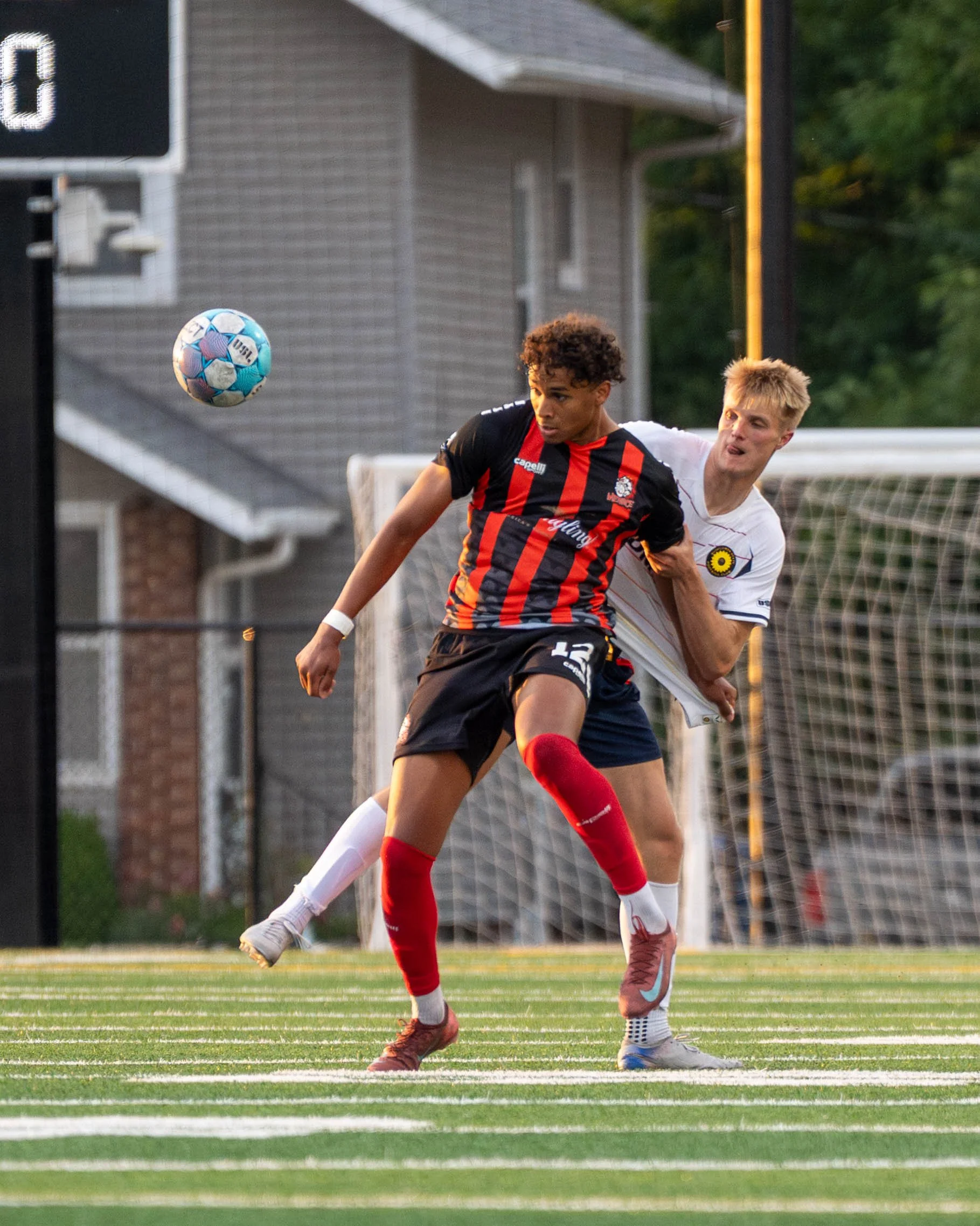 Des Moines Menace shielding to win a contested ball with an opponent on his back at home against Sunflower State FC on May 30th, 2026 - Photo by: Austin Farrow