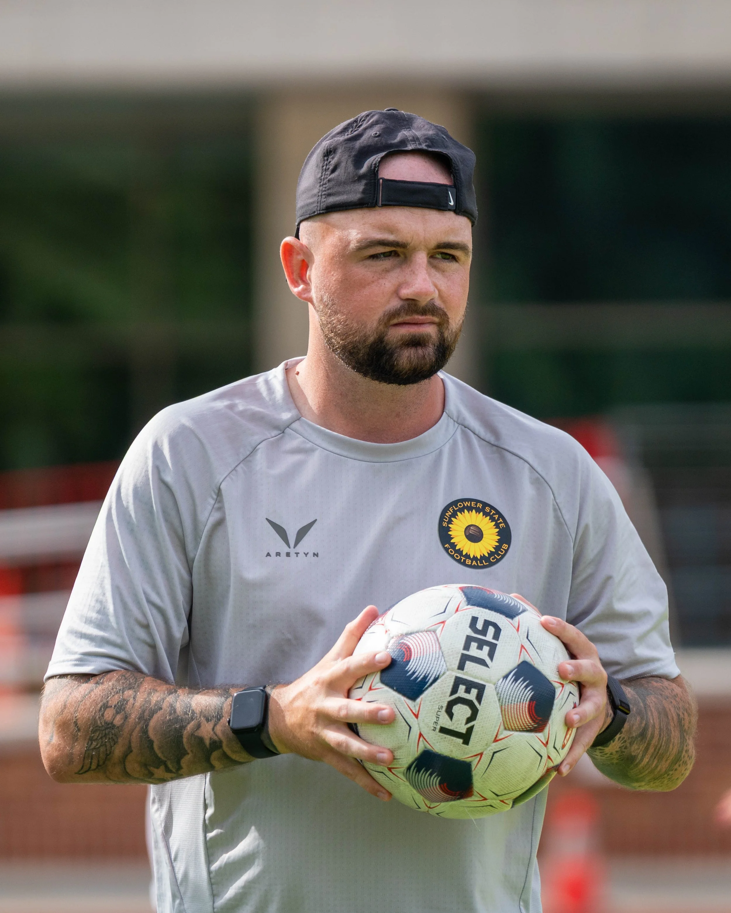 Sunflower State FC coach Alistair Hughes holds a ball during warmups at home vs Oklahoma City FC on June 6th, 2026 - Photo by: Austin Farrow