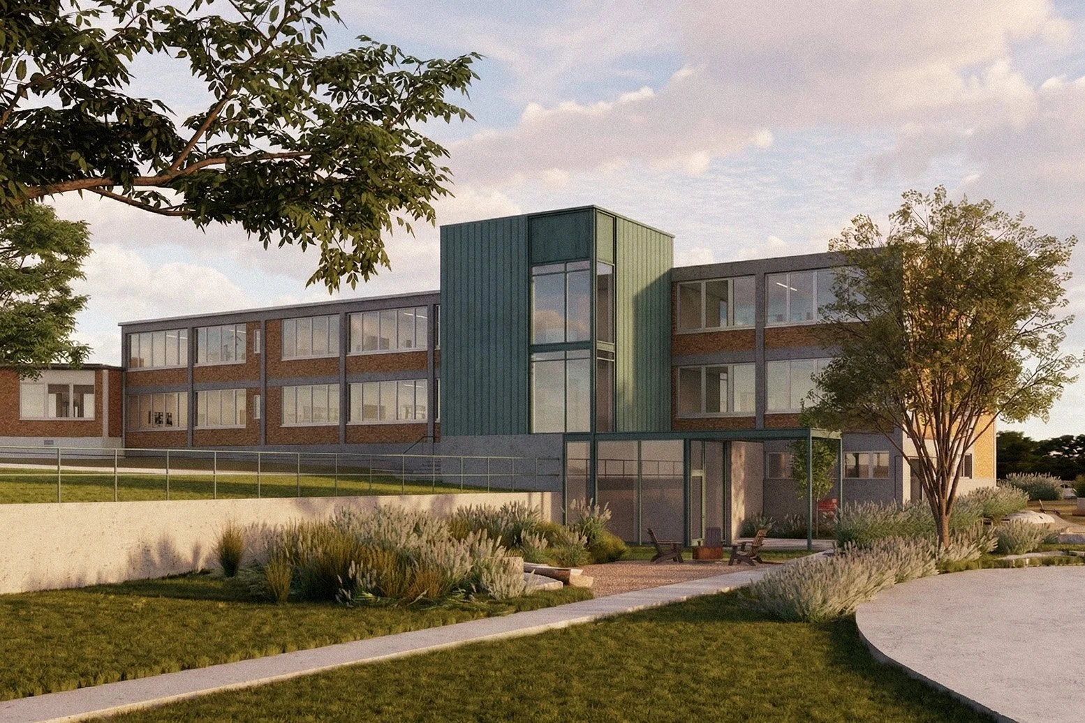 Modern multi-story building with large windows, surrounded by landscaped gardens and trees, during sunset.
