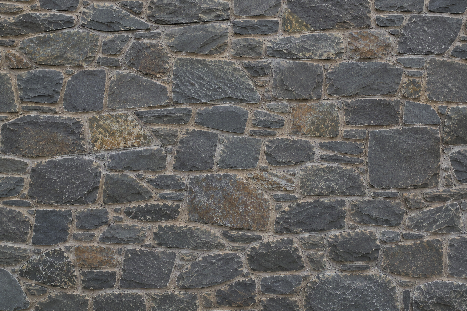 Close-up view of a stone wall with irregularly shaped gray and brown stones set in mortar.