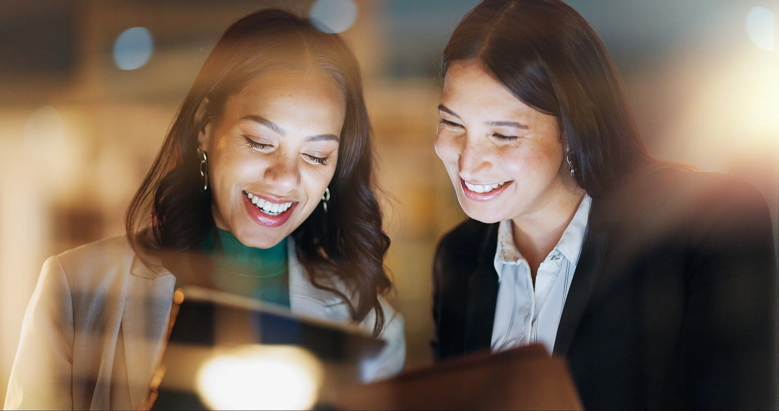 Two women enjoying their workplace, finding direction and satisfaction through work. Both have had effective career counselling.