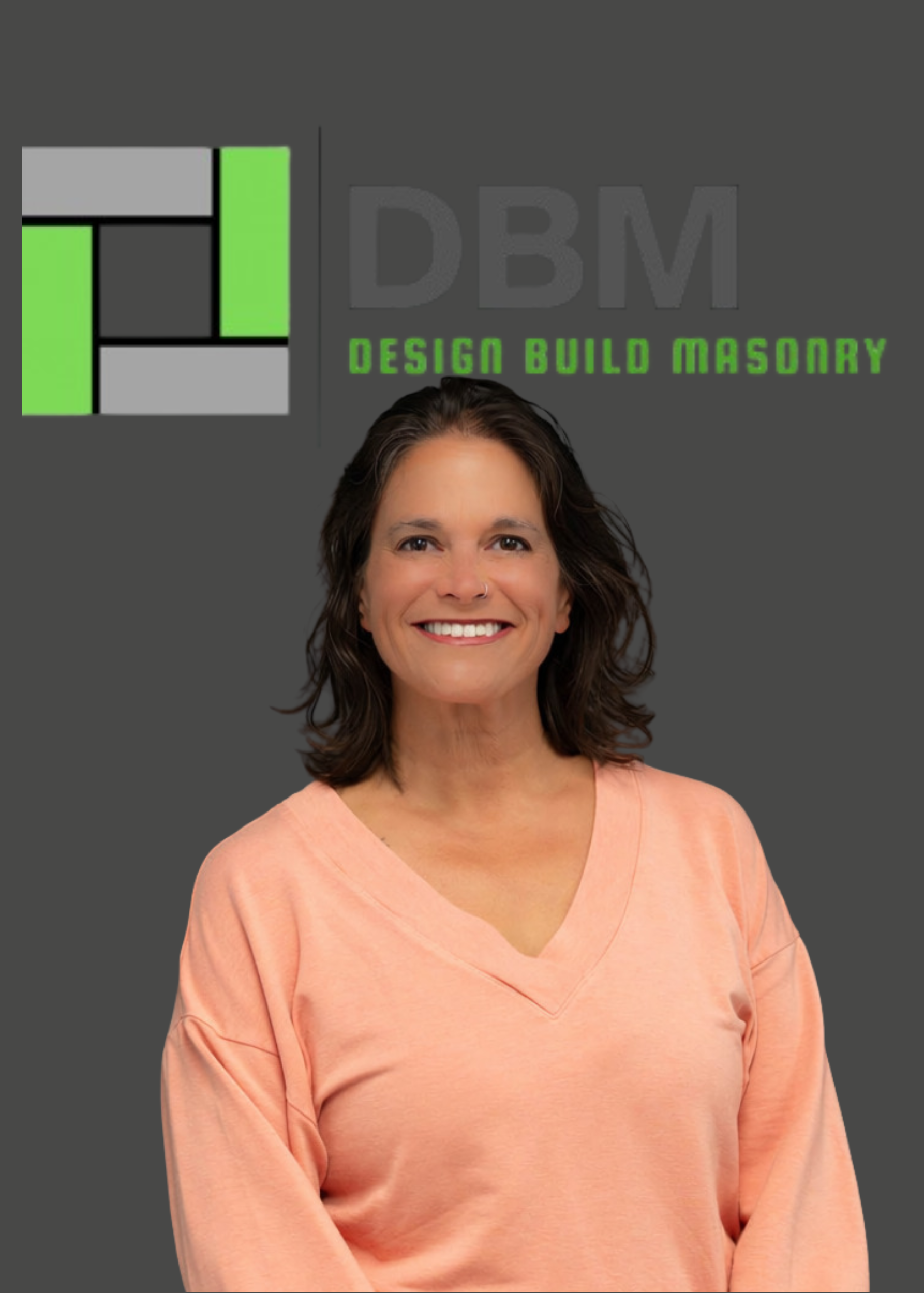 A woman with short brown hair smiling, wearing a peach-colored V-neck shirt, standing in front of a dark gray background with a logo reading "DBM Design Build Masonry" and a graphic design in black, gray, and green.