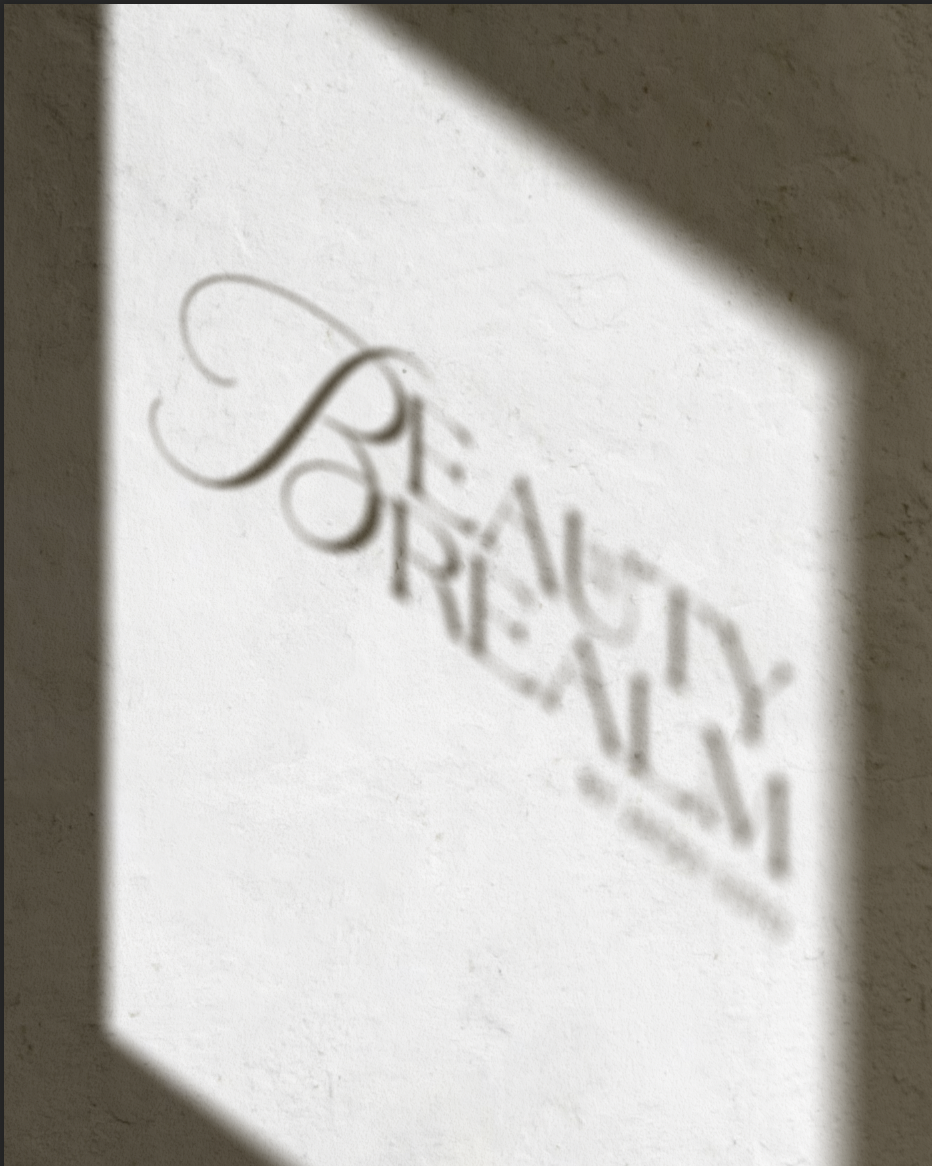 Shadow of the word 'BEAUTY' cast on a wall.