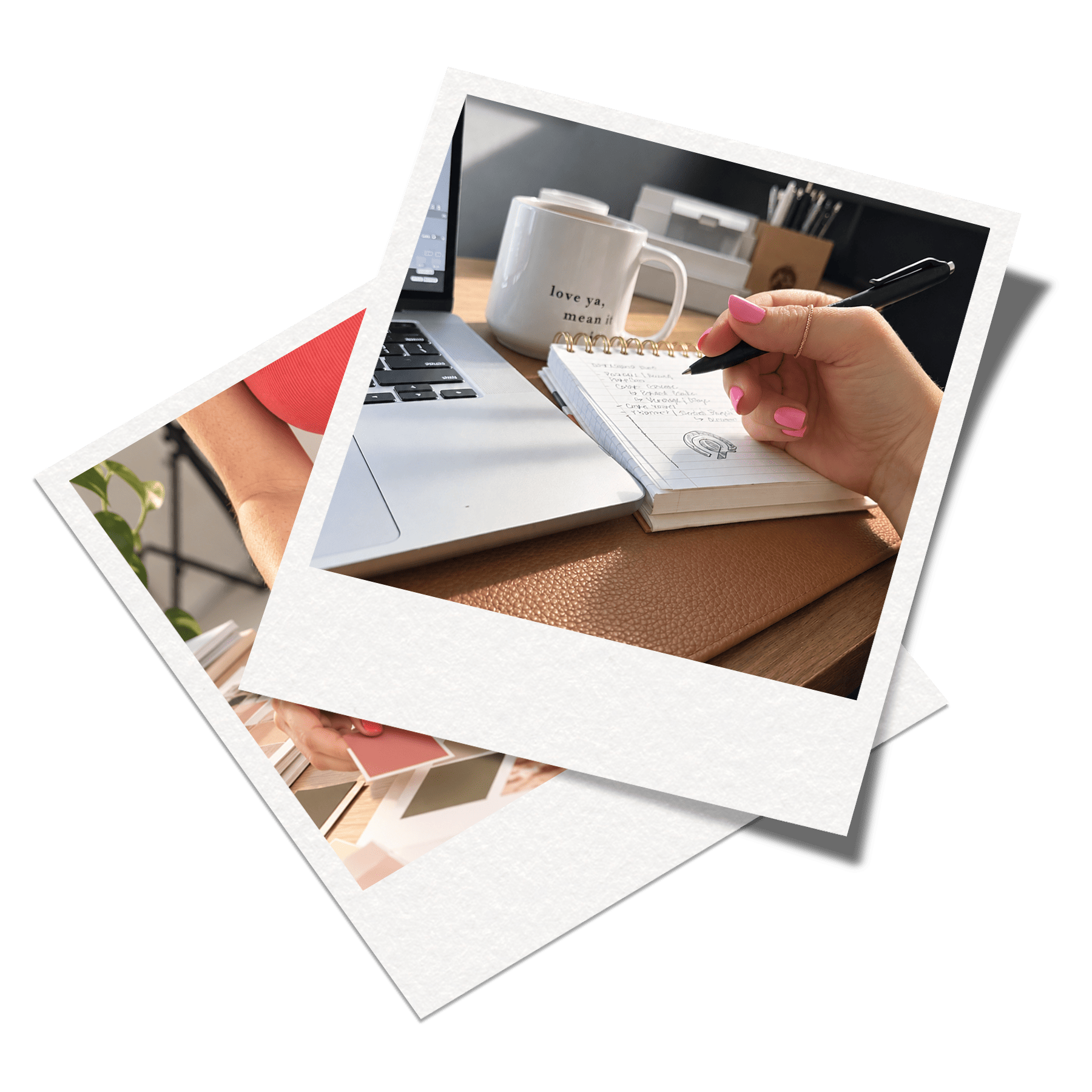 A person's hand with pink nails holding a black pen over a spiral notebook with handwritten notes. There is a white coffee mug with the words 'love ya, mean it' printed on it, a laptop, and a box filled with pens and papers on a wooden desk.