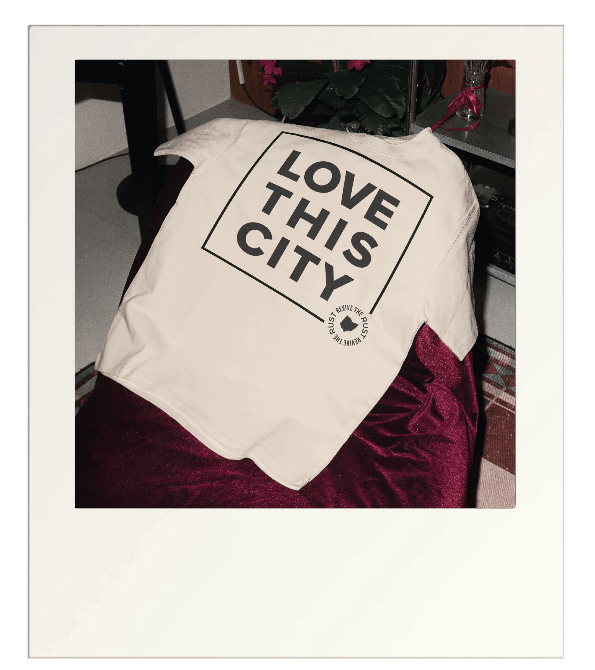 white t-shirt says love this city with square box around text
