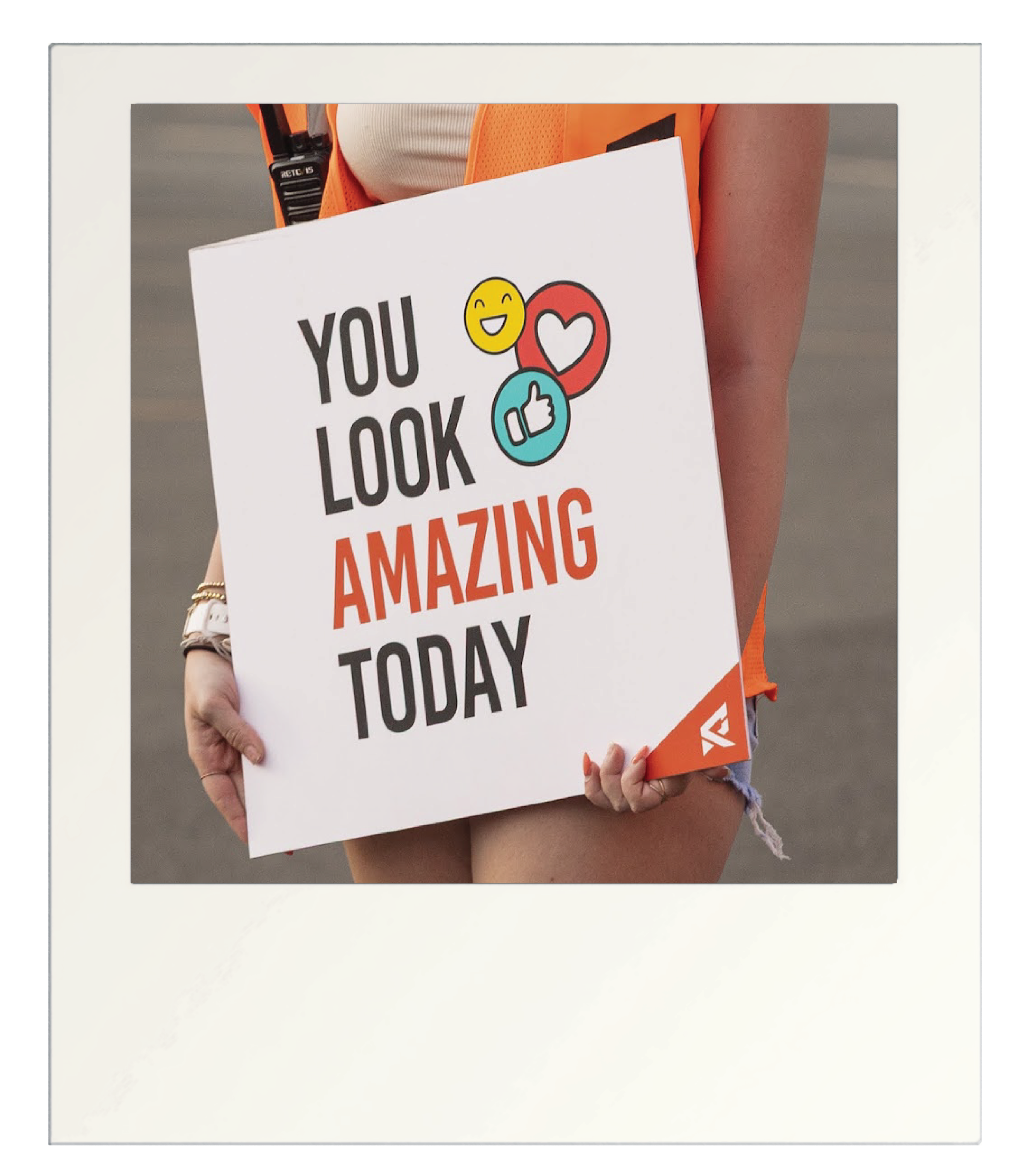 girl holding pop up sign says you look amazing today with emojis