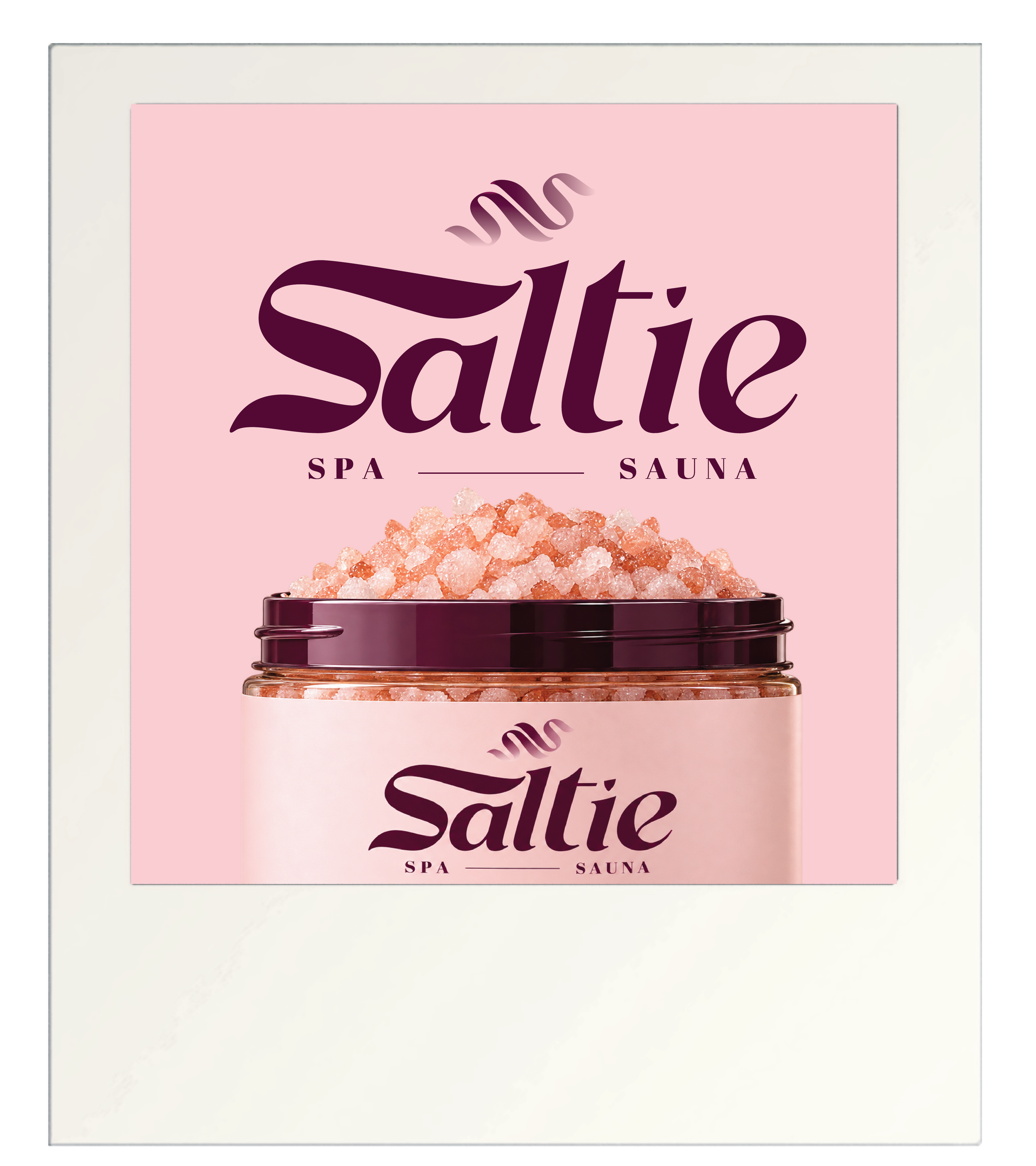 Pink packaging for salt with the words "Saltie" large, purple font, and "Spa" and "Sauna" in smaller font underneath. The package is topped with a clear section showing coarse pink salt crystals inside.