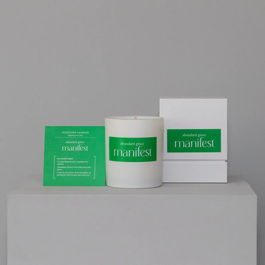 A white mug with a green label reading 'narest' on a light gray surface, accompanied by a small green card and a white box, all with matching green branding.