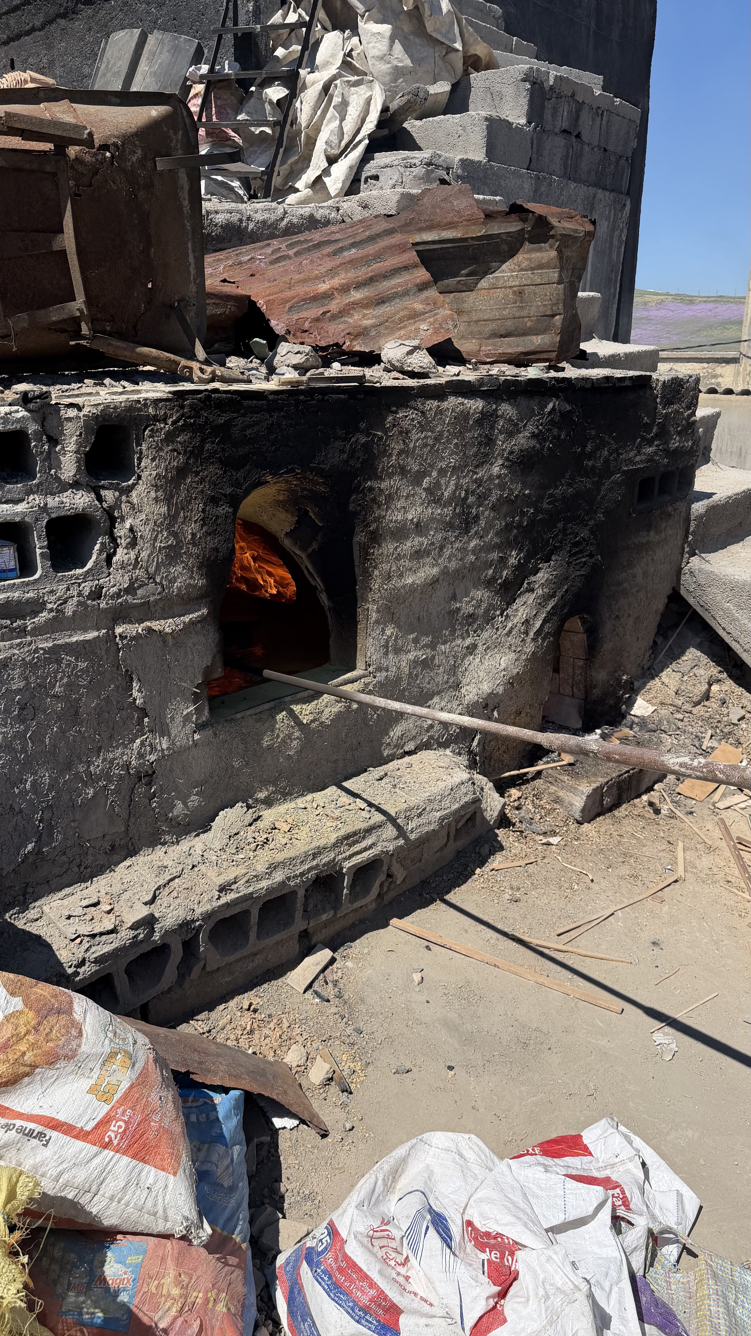 Traditional wood-fired kiln firing handmade tiles in Fez