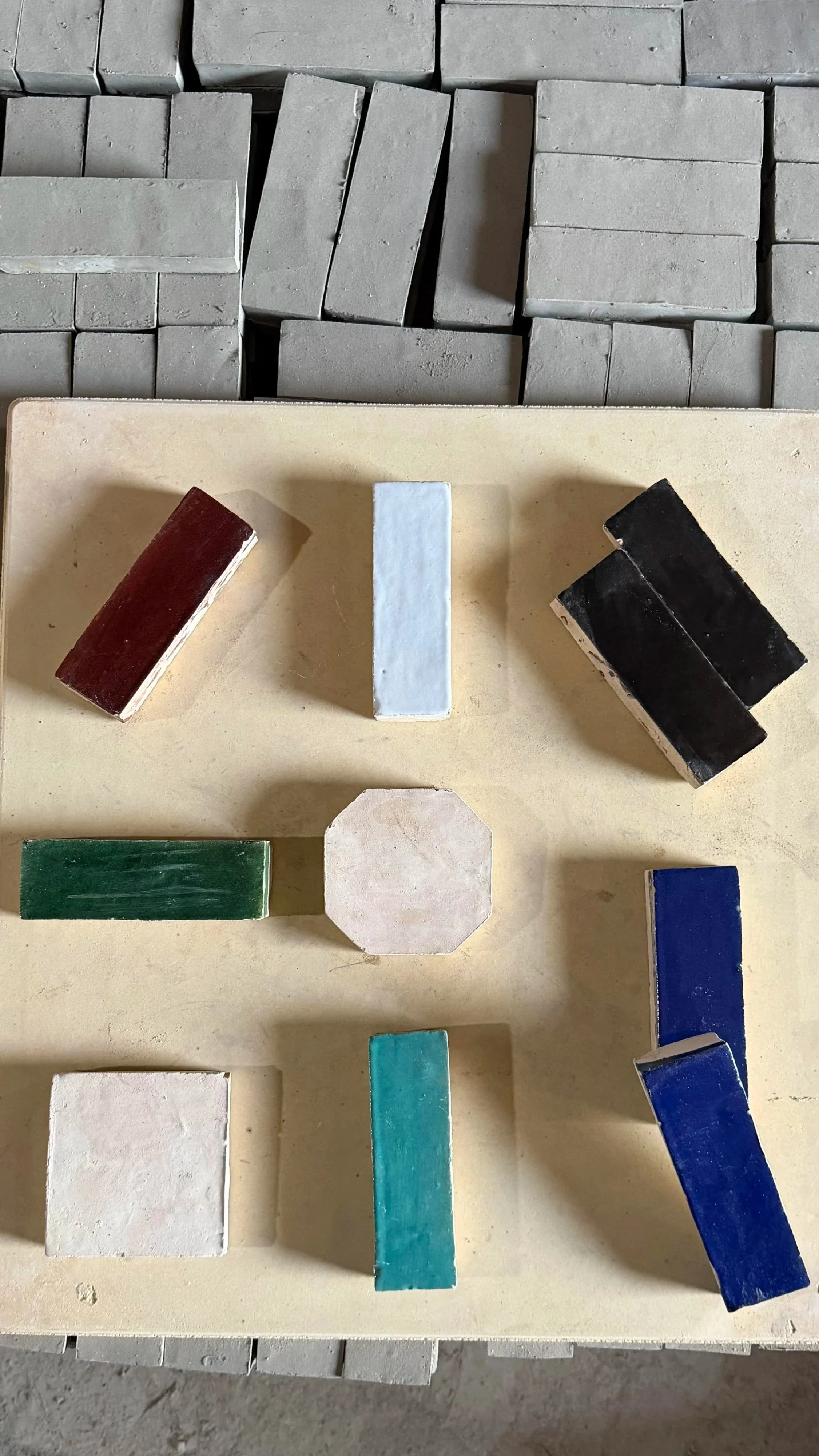 olored handmade tile samples in various Moroccan clay finishes