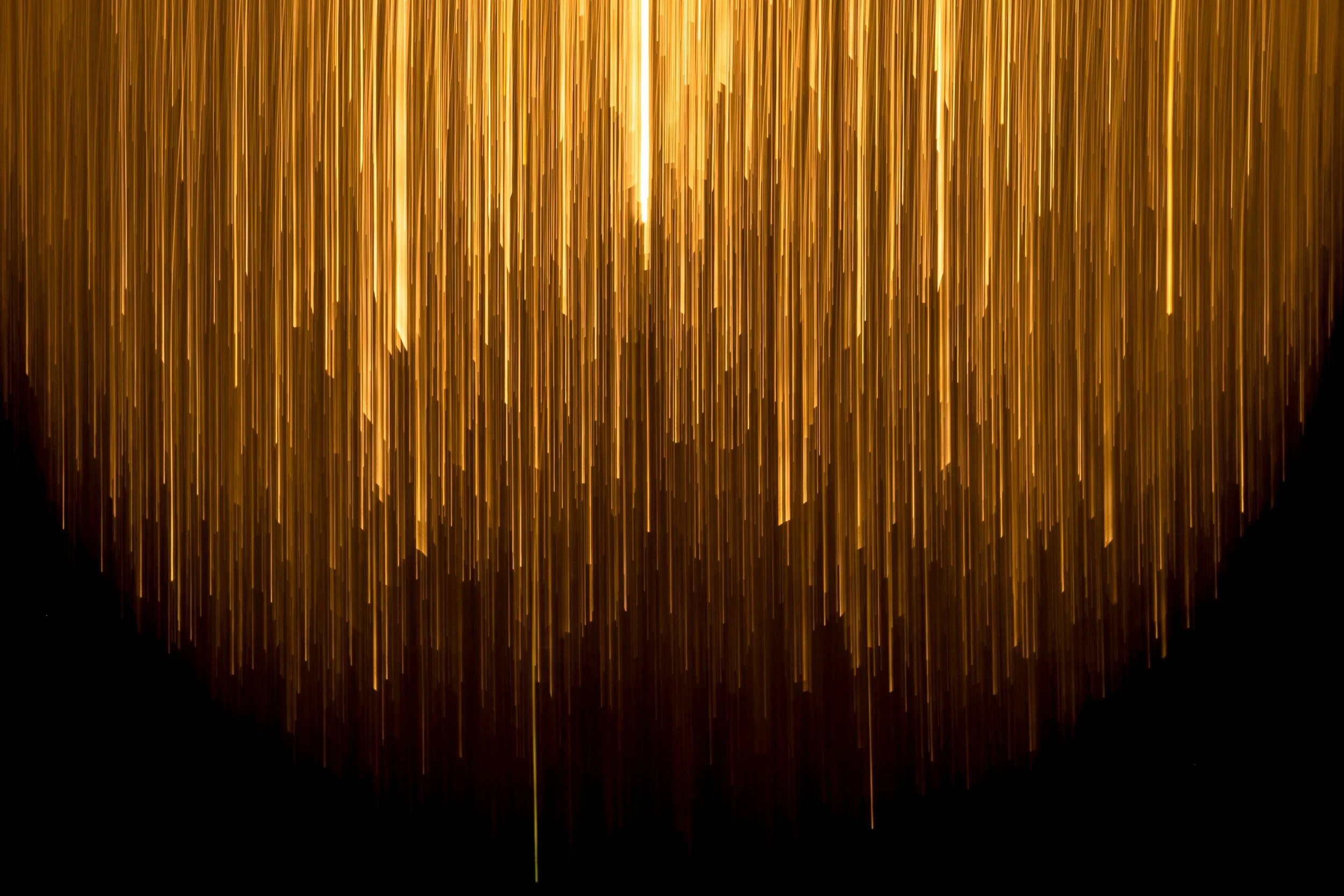 Golden metallic streamers hanging from the top, creating a shimmering curtain effect.
