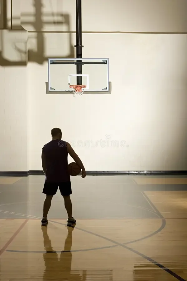 basketball-player-alone-basketball-court-62810236.jpg.webp