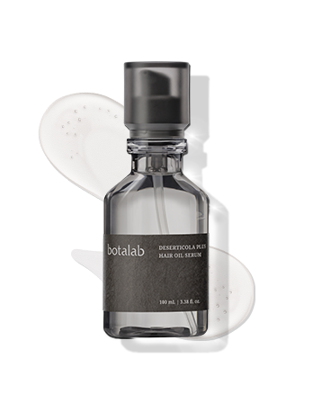Bottle of RIMAN's Botalab deserticola plus hair oil serum with a spoonful of serum in the background.