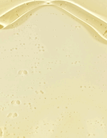 Close-up of smooth, creamy, pale yellow liquid with small bubbles, possibly a beverage or dessert mixture.