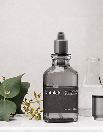 A clear RIMAN bottle of shampoo with a black label and grey pump dispenser, surrounded by green leaves and small yellow flowers, with other bottle in the background.